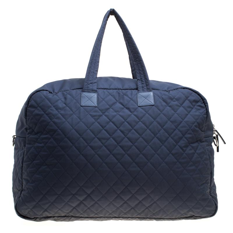 Exuding a classic, elegant vibe, this Weekender bag from Chanel in a subtle navy blue hue will make you forget all the other bags you have seen or liked. It is spacious and durable and is crafted from nylon with the signature quilted pattern. The