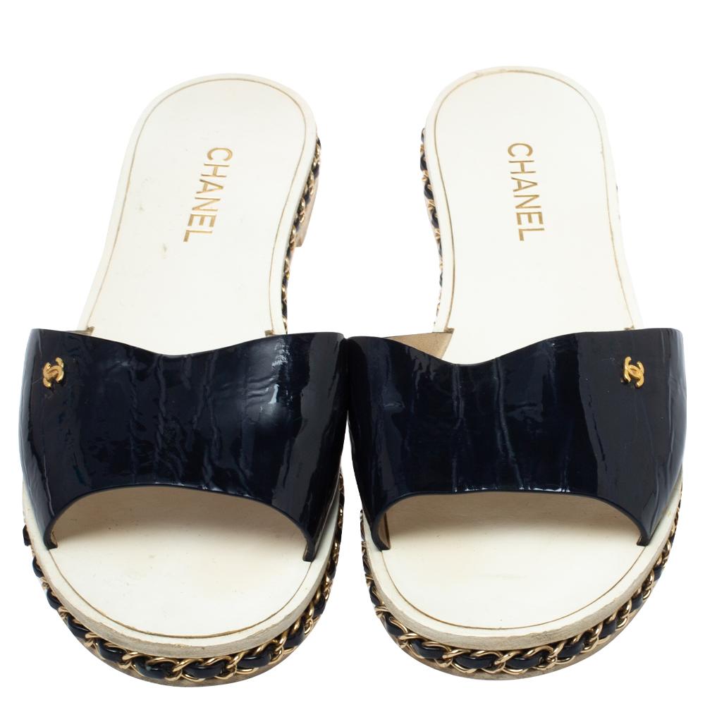 Chanel understands your need for comfort and style in these flat sandals. The straps are made from patent leather, and the leather insoles keep your feet feeling comfortable all day. The midsoles are accented with chain detailing that adds the right