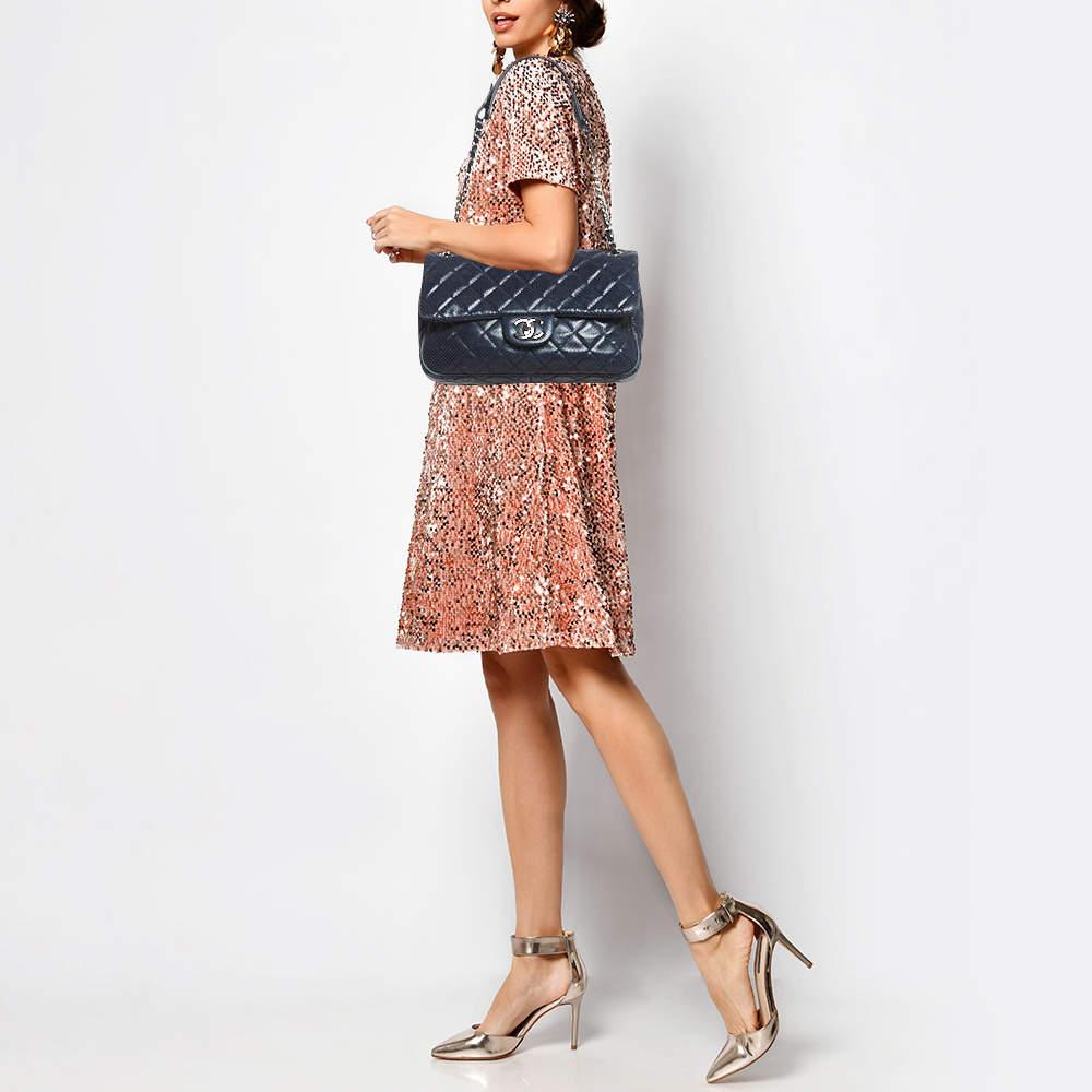 Chanels Flap Bags are iconic and noteworthy in the history of fashion. Hence this Punch flap bag is a buy that is worth every bit of your splurge. Exquisitely crafted from perforated leather it bears the iconic CC turn lock on the flap. The piece