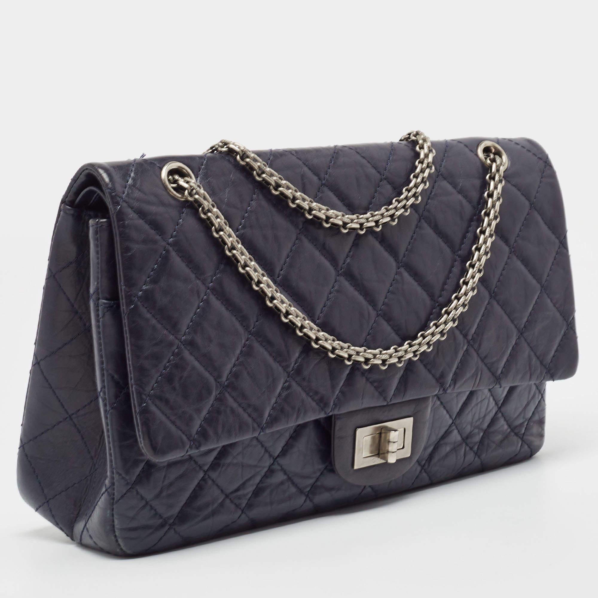 Indulge in timeless luxury with this Chanel 227 Reissue 2.55 flap bag. Meticulously crafted, this iconic piece combines heritage, elegance, and craftsmanship, elevating your style to a level of unmatched sophistication.

