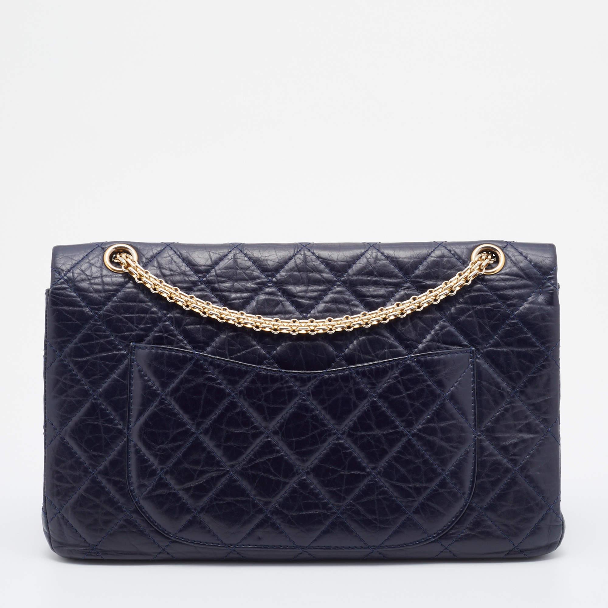 Chanel's Flap Bags are iconic and noteworthy in the history of fashion. Hence, this Reissue 2.55 is a buy that is worth every bit of your splurge. Exquisitely crafted from navy blue crinkled leather, it bears their signature quilt pattern and the