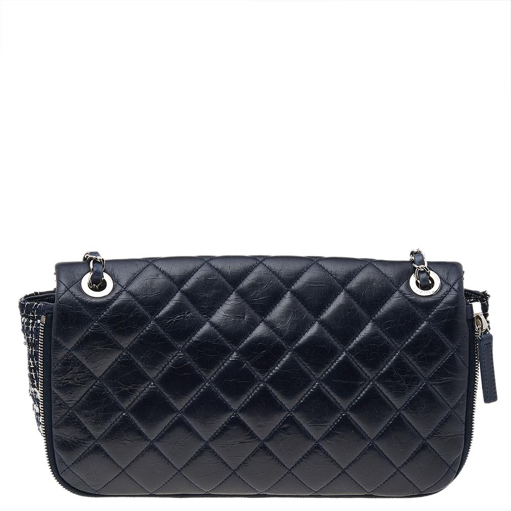 We are in utter awe of this flap bag from Chanel as it is appealing in a surreal way. Exquisitely crafted from leather & tweed in their quilt design, it bears the signature label on the fabric interior and the iconic CC turn-lock on the flap. The