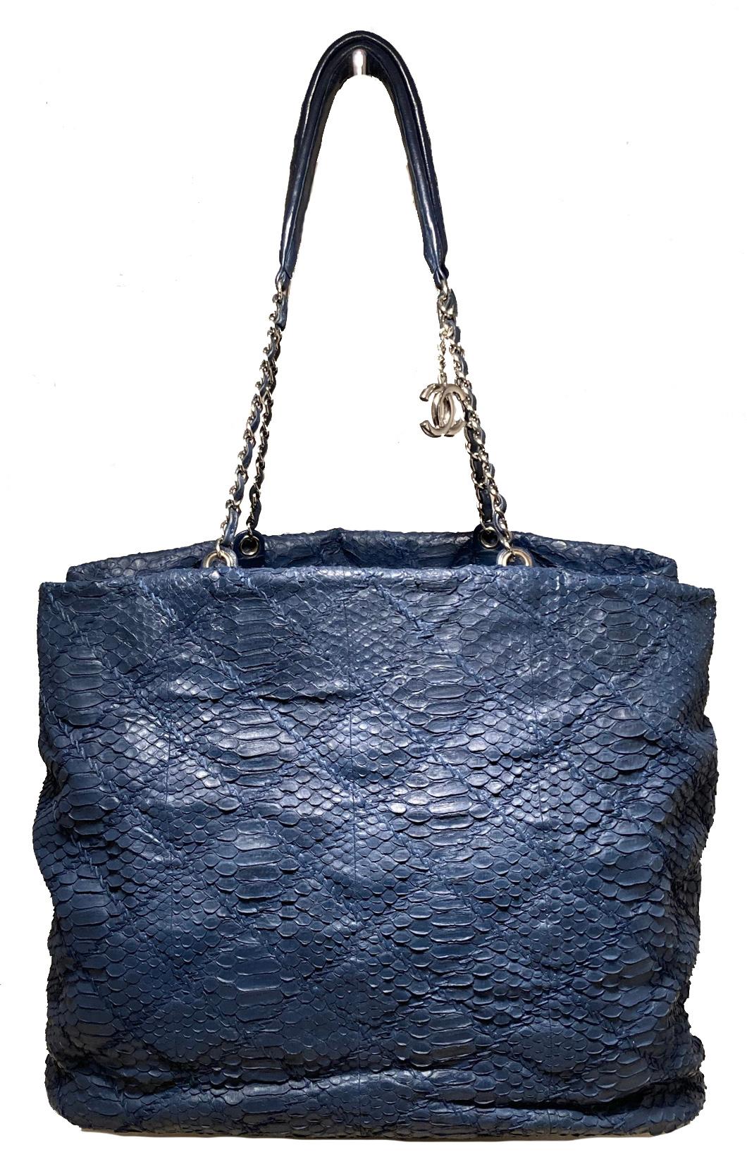 Chanel Navy Blue Quilted Matte Snakeskin Tote in excellent condition. Quilted navy blue matte snakeskin exterior trimmed with silver hardware and matching navy blue leather. Double woven chain and leather shoulder straps. Silver CC logo charm upon