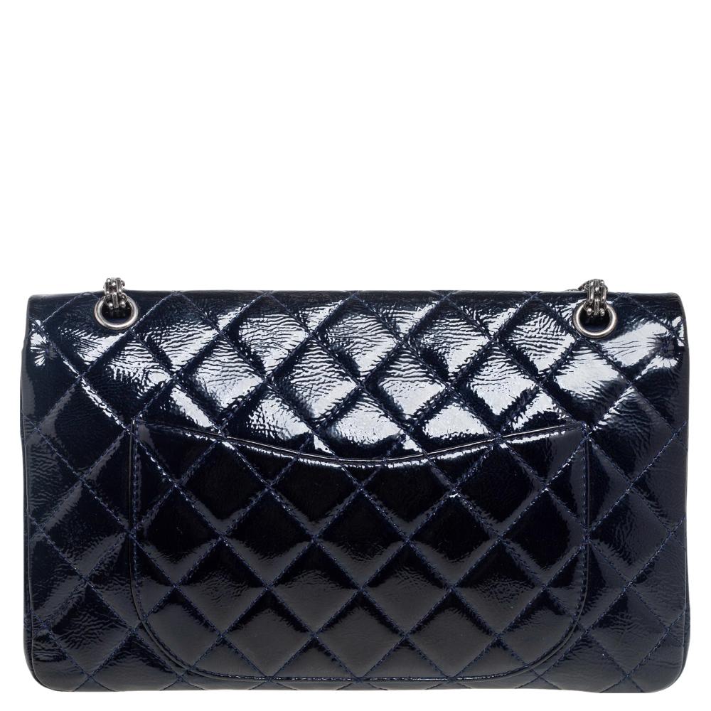 Introduce Chanel's irreplaceable style to your closet with this Reissue 2.55 Classic 227 flap bag. Crafted using patent leather, the navy blue bag has a signature quilted exterior, the Mademoiselle lock on the front, and a leather-lined interior.