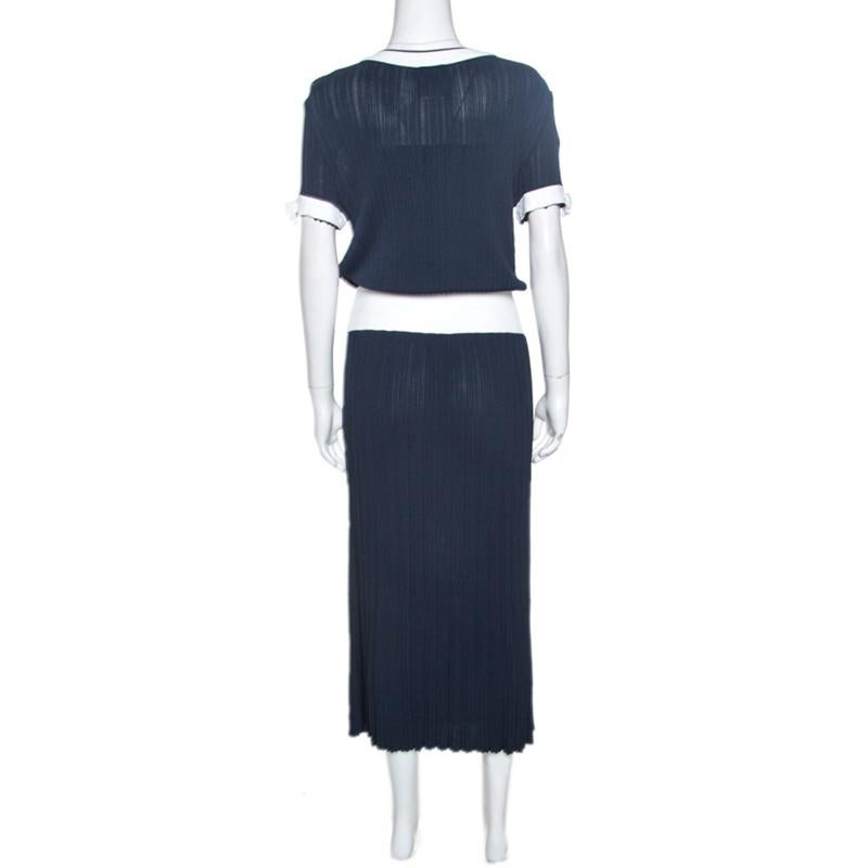Granting a flattering silhouette, this dress from Chanel is a melange of label's elegant aesthetics and feminine details. It is cut from a blend of quality fabrics and features a textured finish. Short sleeves and the comforting length makes the