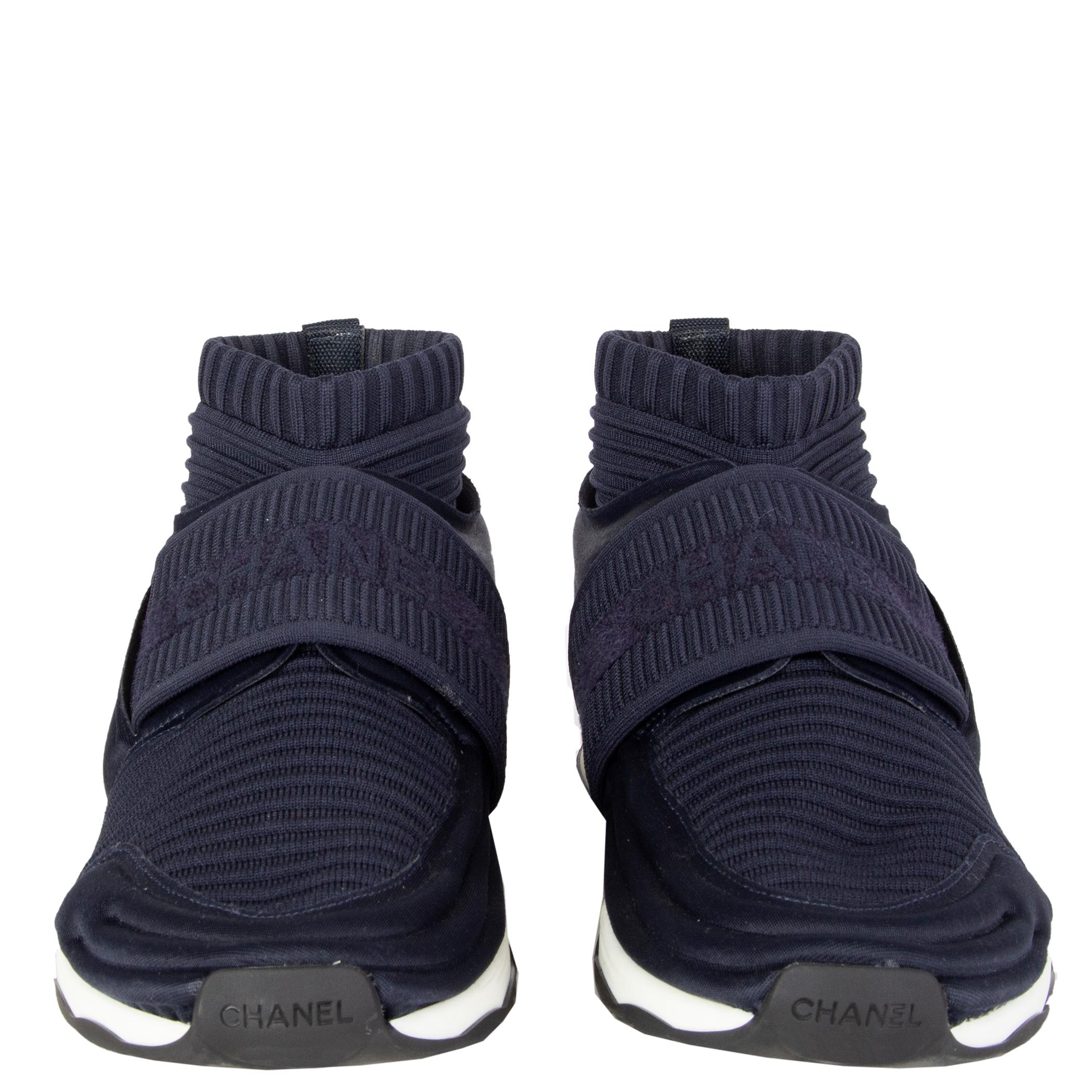 Chanel stretch-knit sock speed sneakers in midnightblue elastic ribbed jersey and neoprene featuring a white rubber sole. Interlocking CC pull-tab at counters, rubber soles and elasticized strap at uppers featuring logo. Have been worn once and are