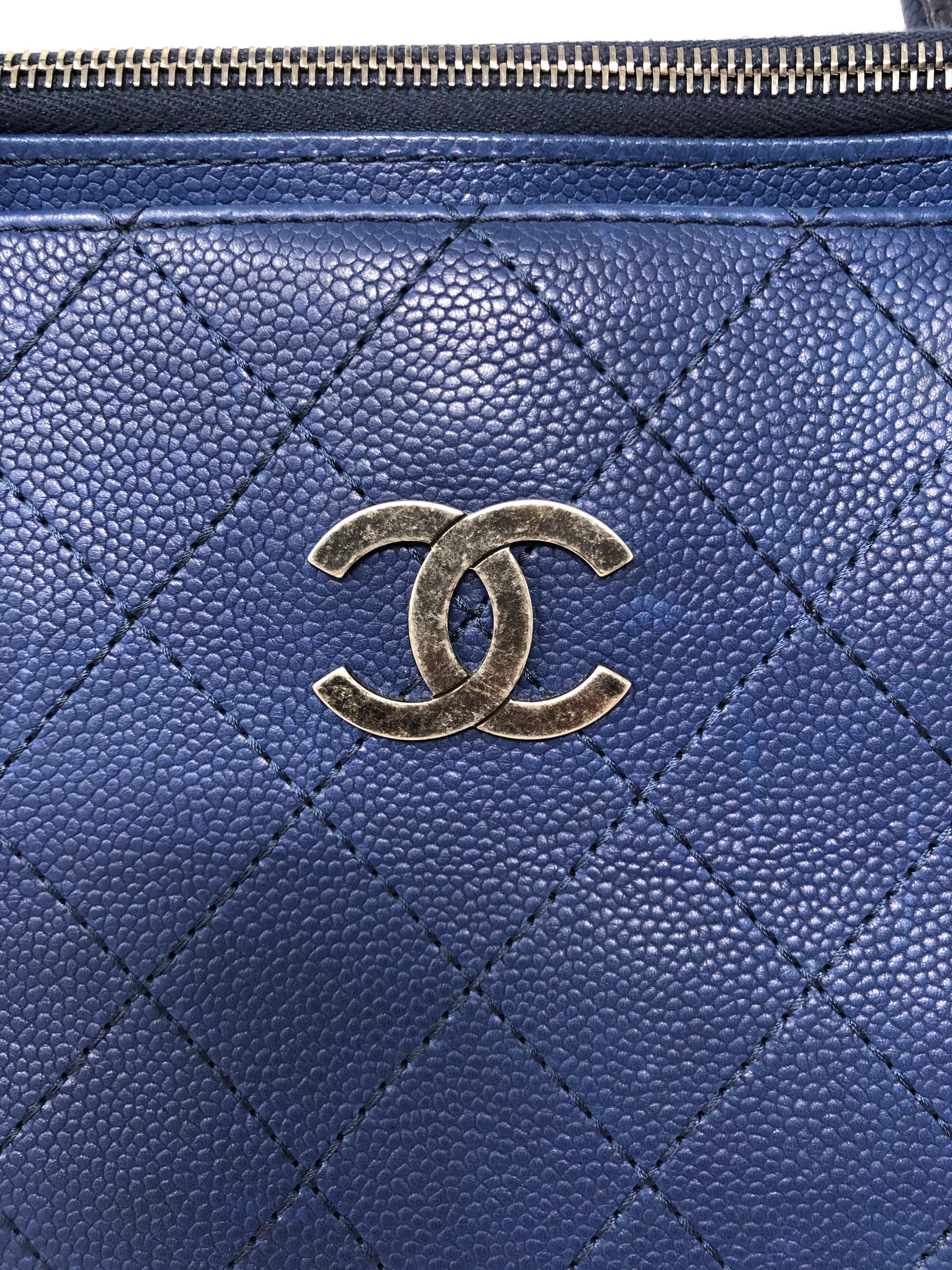 Chanel Navy Blue Tote Bag. Antique silver hardware. Durable caviar leather in mint like new condition. Can be worn 2 ways. Great for carrying all your essentials. Makes a great work bag. Guaranteed authentic. 