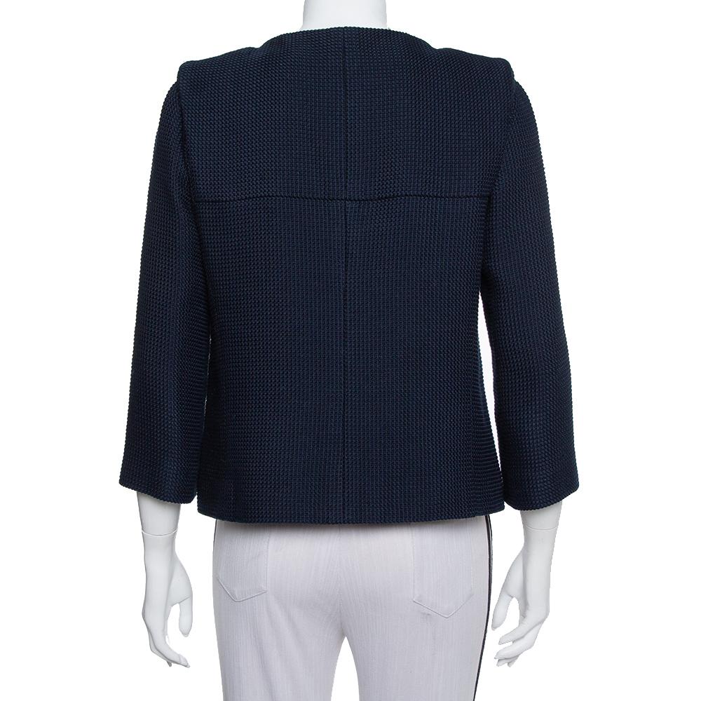 This amazing jacket from Chanel is incredibly chic and effortlessly stylish. The navy blue tweed creation is designed in a flattering silhouette with a round neckline, front button fastenings, two pockets, and long sleeves. It will lend you a