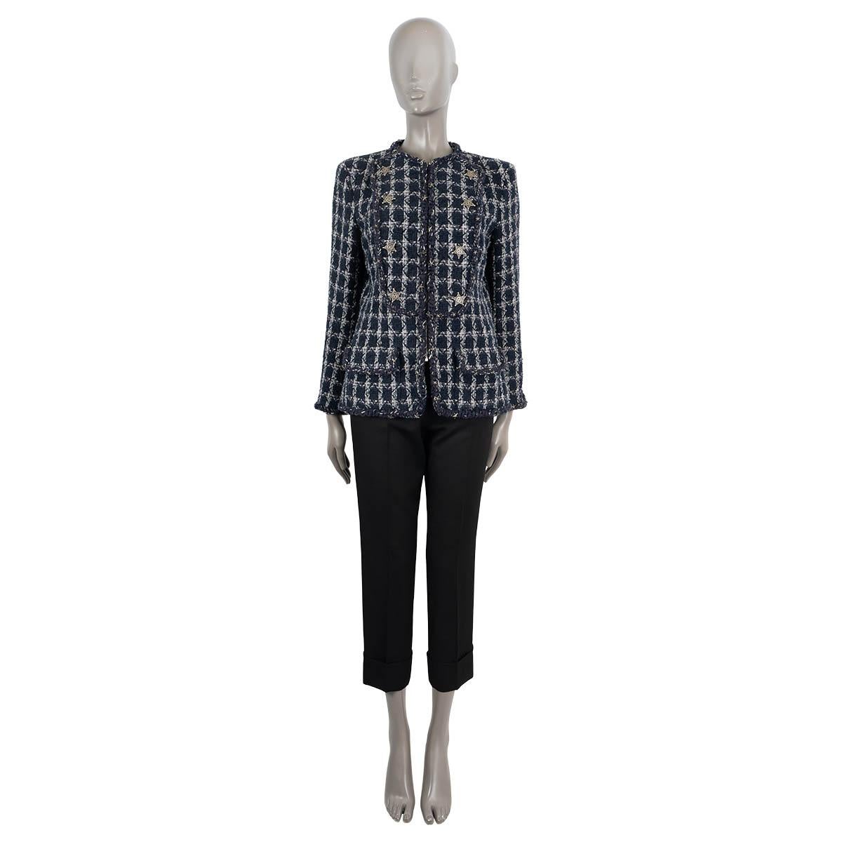 100% authentic Chanel collarless tweed jacket in navy blue, white, grey and black cotton (84%), wool (10%) and nylon (6%). Features a round neck, braided trims, star pins, a bib panel and two flap pockets. Closes with a concealed zipper on the