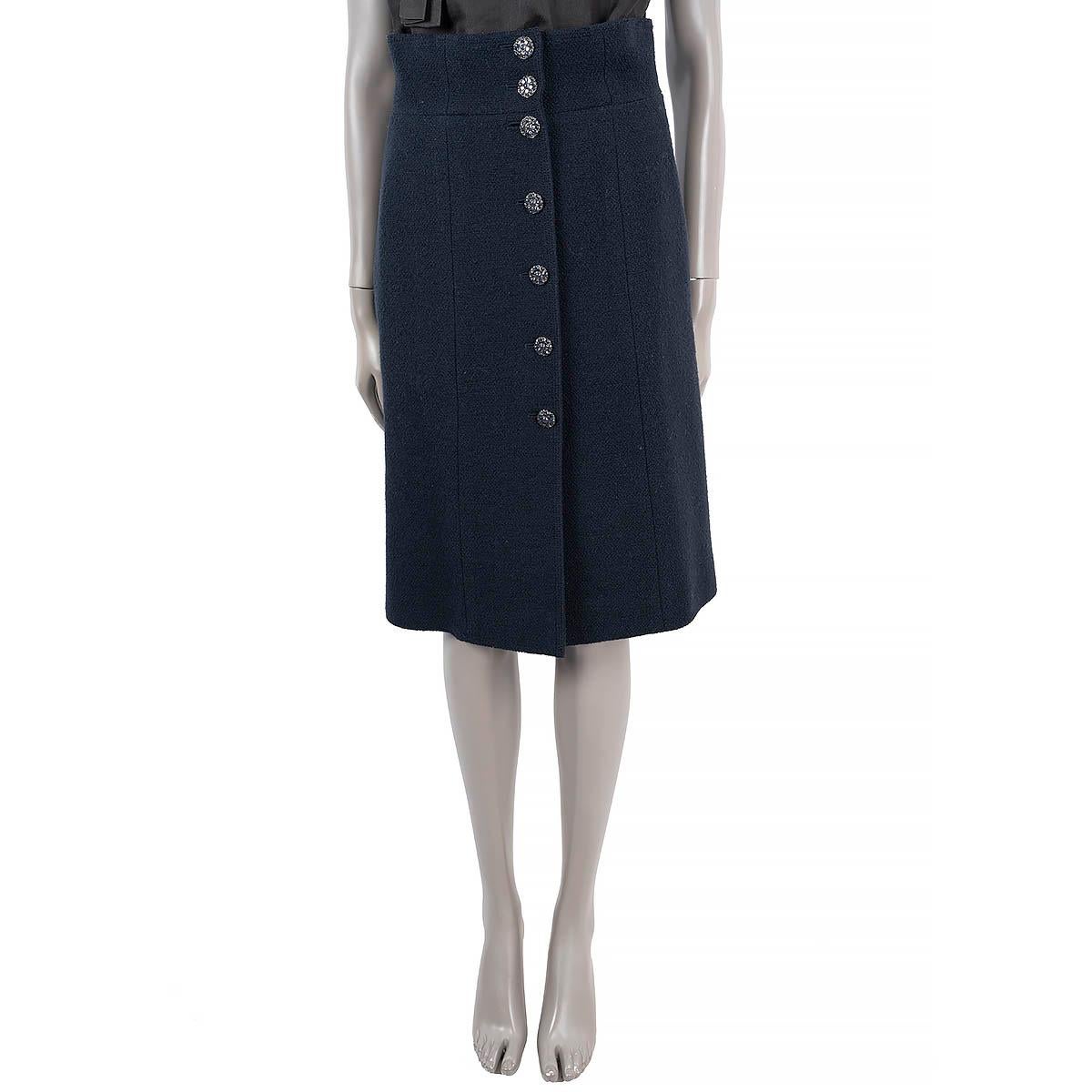 100% authentic Chanel tweed skirt in navy blue wool (100%). Features two pockets on the side and seven Gripoix flower button on the front. Lined in navy blue silk (100%). Has been worn and is in excellent condition.

2015 Paris-Dubai Resort