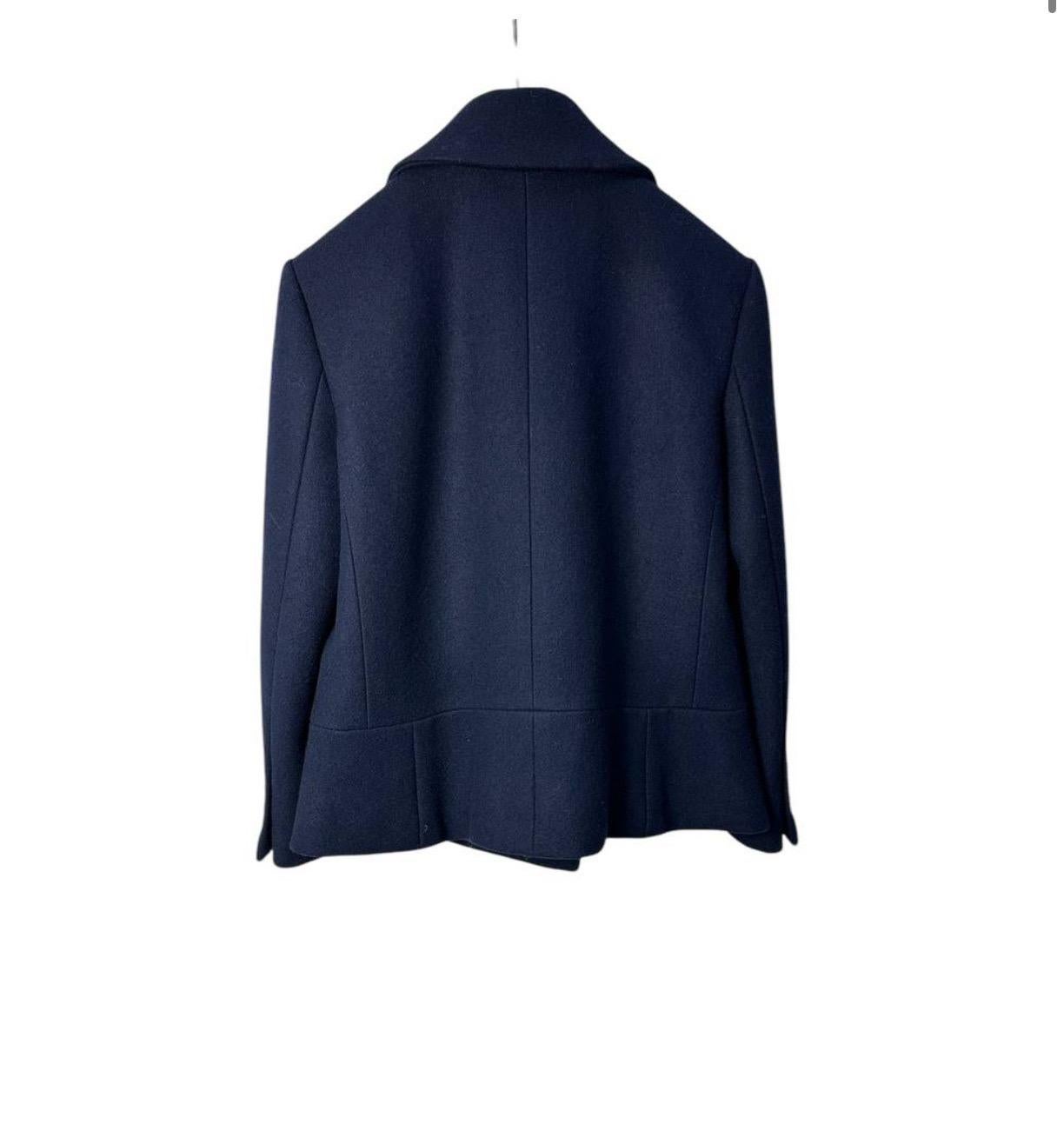 

A classic navy peacoat that fuses military precision with modern elegance. Featuring a double-breasted front, broad lapels, and oversized patch pockets, it creates a flawless silhouette that radiates quiet confidence. Ideal for transitional