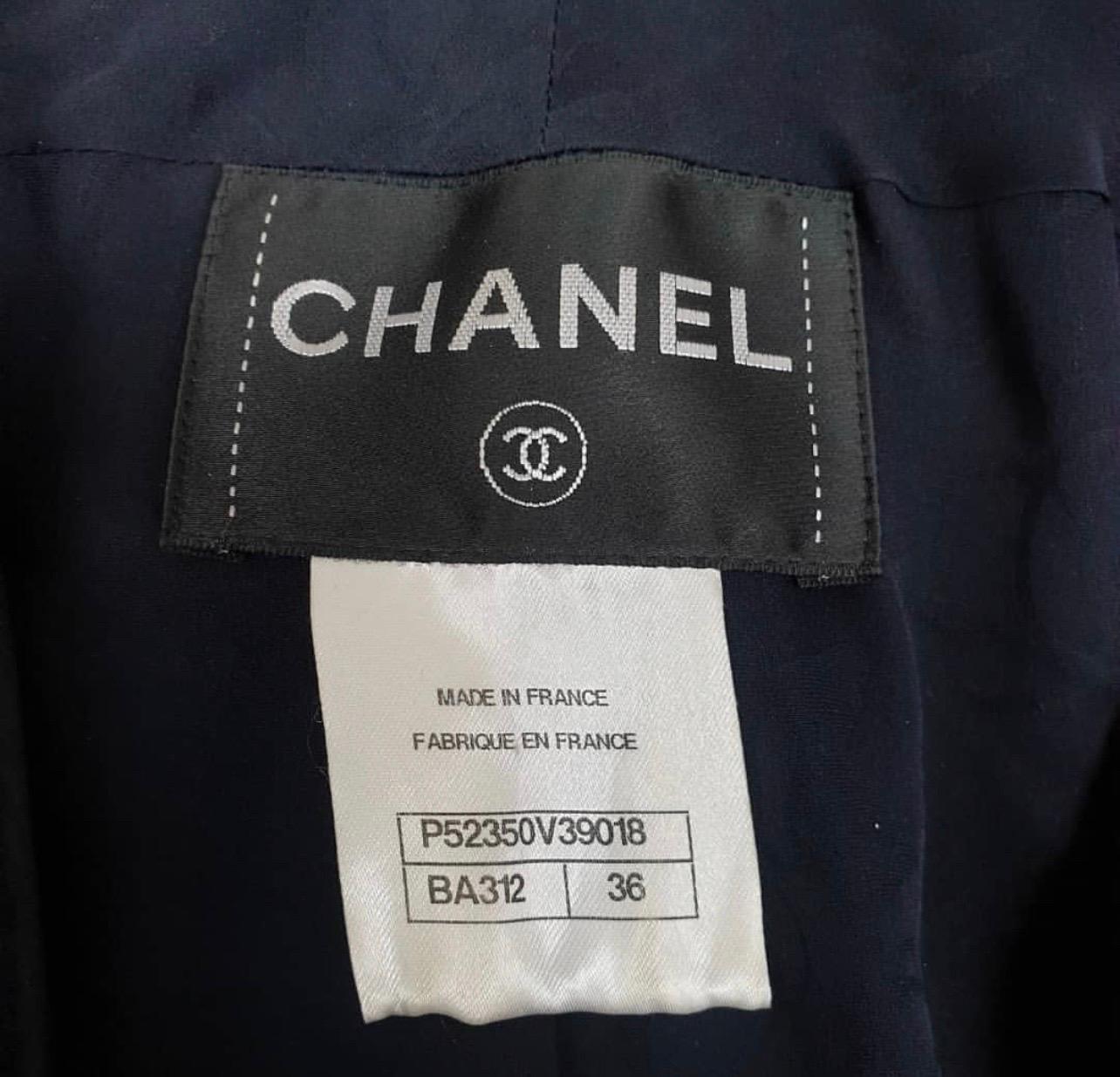 Chanel jacket made of navy textured tweed. 
V-neck collar line, large round tweed buttons with brand's logo. 
Silk lining.
Perfect condition.
Hanger is not included.
Sz.36
For buyers from EU we can provide shipping from Poland. Please demand.