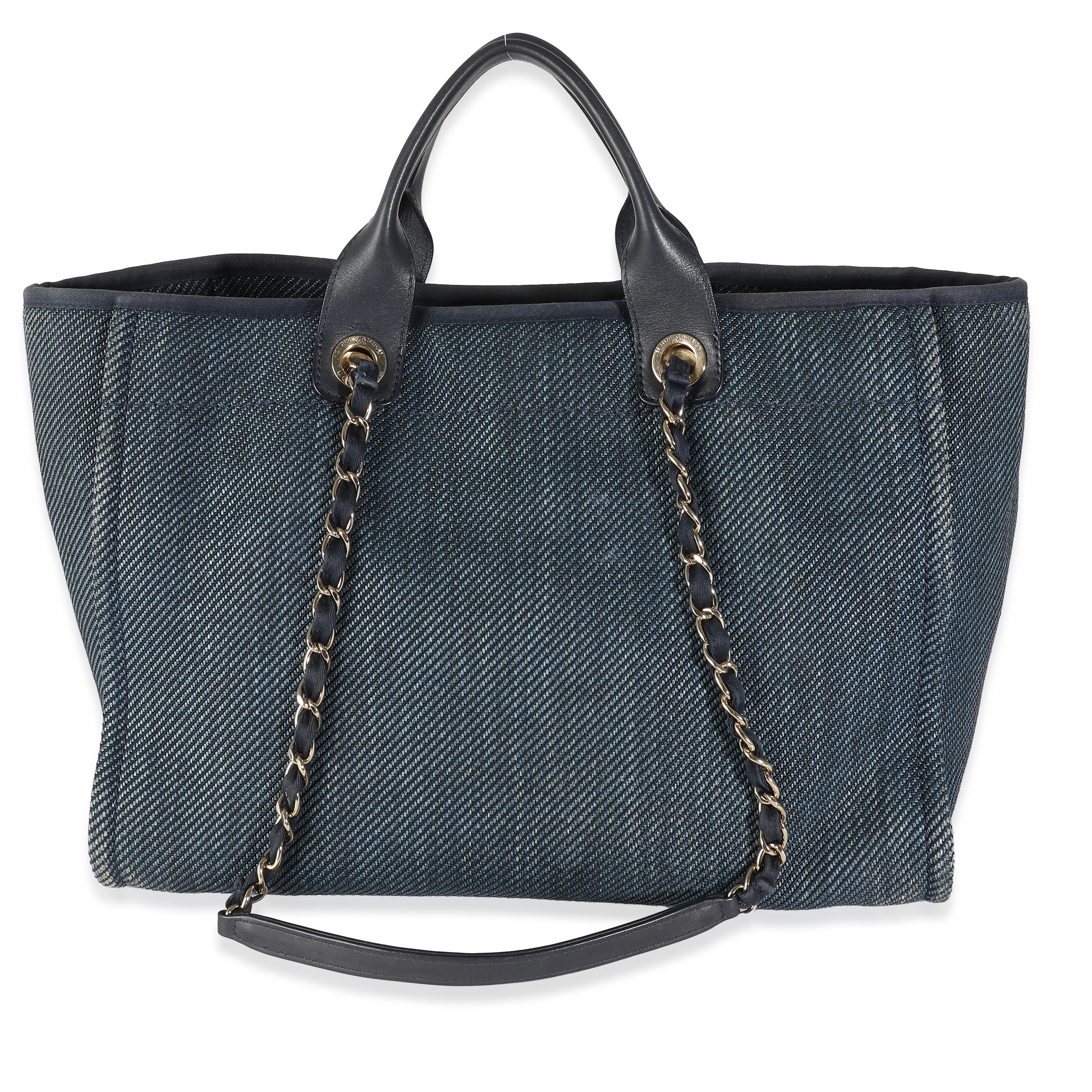 Listing Title: Chanel Navy Blue Woven Straw Raffia Medium Deauville Tote
SKU: 141898
Condition: Pre-owned 
Condition Description: Intrinsically Chanel, the medium Coco top handle bag was named after the maison's founder. Introduced in 2015, the bag