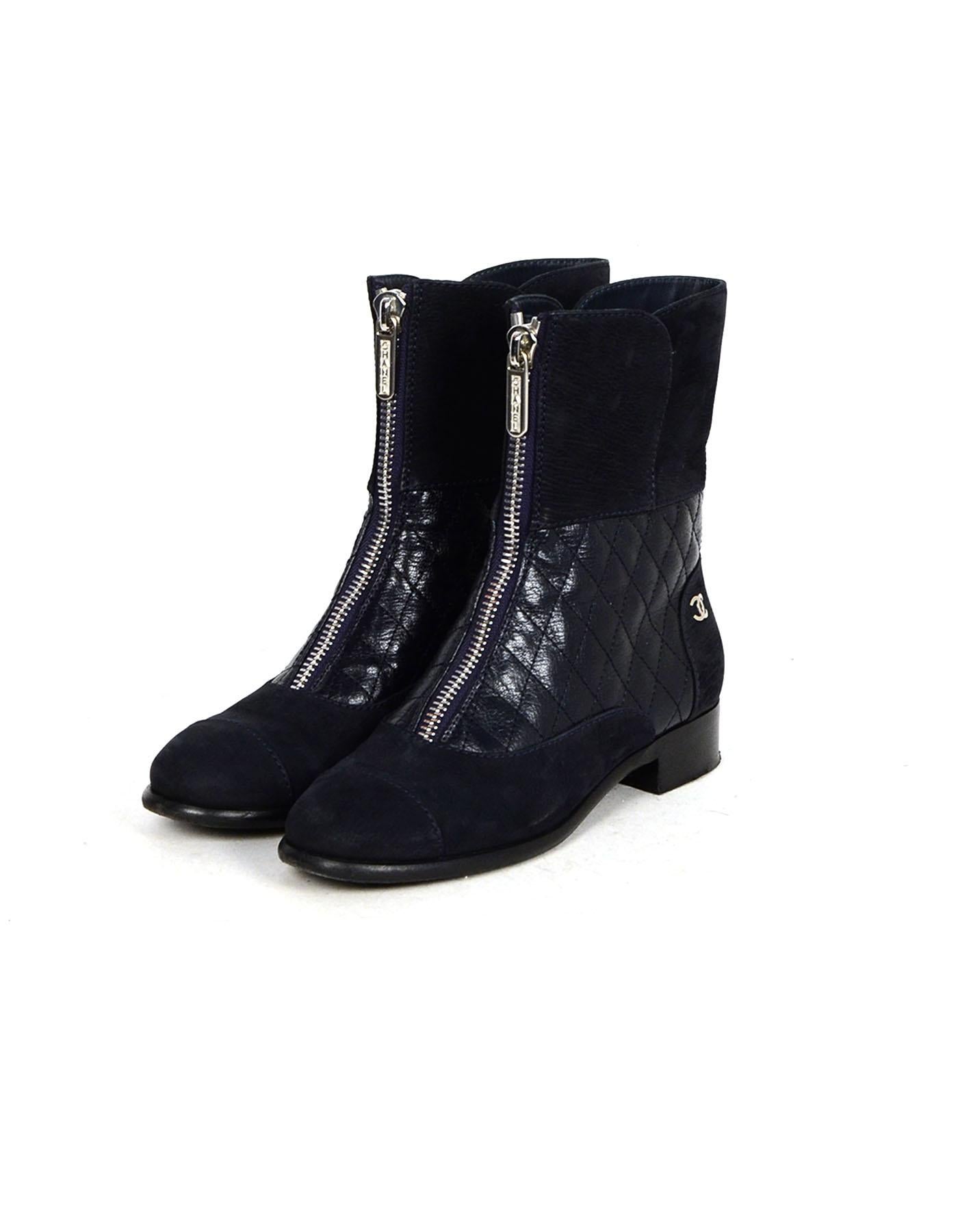 Chanel Navy Calfskin Quilted Zip Front Boots sz 37

Made In: Italy
Year of Production: 2016
Color: Blue
Hardware: Silvertone hardware
Materials: Calfskin leather, suede trim
Closure/Opening: Front zip
Overall Condition: Very good pre-owned