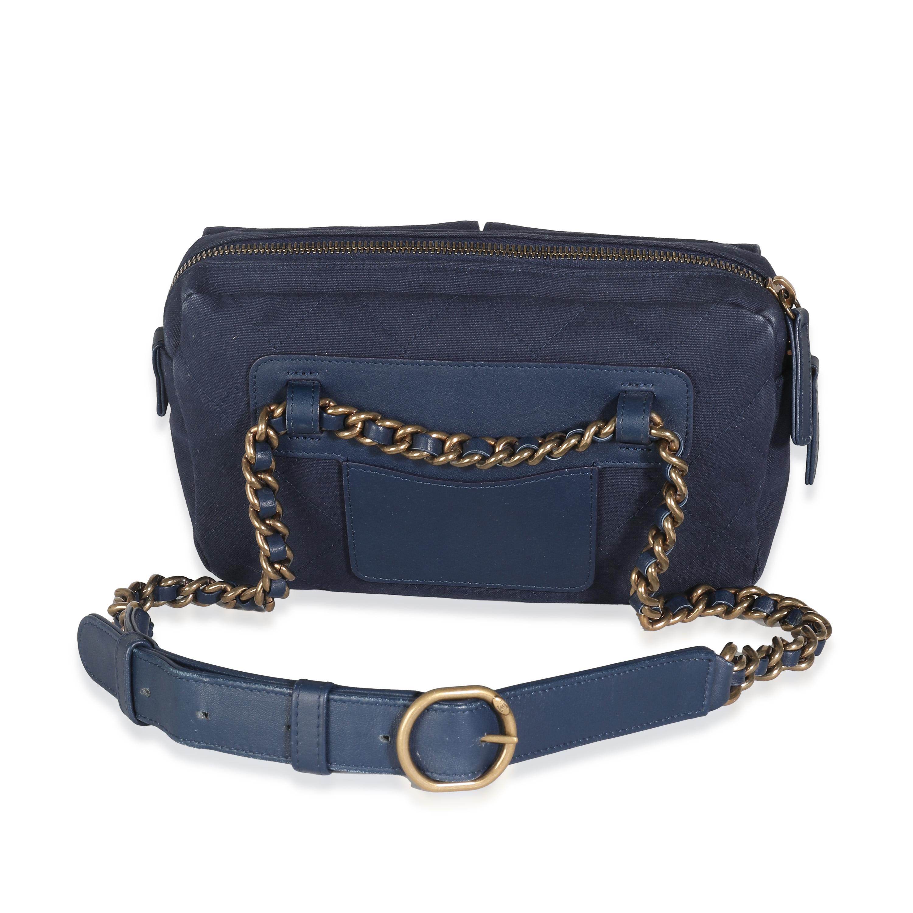 Listing Title: Chanel Navy Canvas Double Pocket Waist Bag
SKU: 140635
Condition: Pre-owned 
Handbag Condition: Excellent
Condition Comments: Item is in excellent condition and displays light signs of wear. Light white marks throughout exterior.