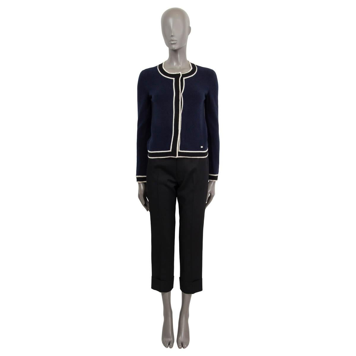 100% authentic Chanel round-neck cardigan in navy blue cashmere (100%) with contrast trim in black and white. Closes with concealed buttons on the front. Has been worn and is in excellent condition.

2002 Resort

Measurements
Model	Chanel02C
Tag