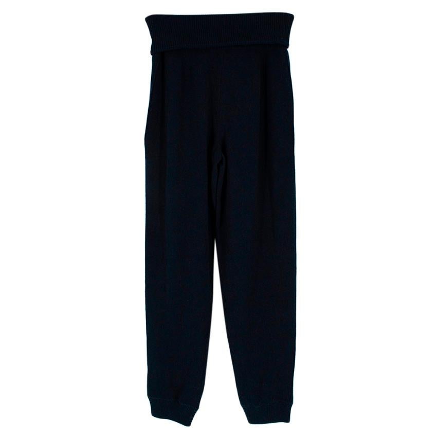 Chanel Navy Cashmere White Stripe Knit Joggers

- Luxurious extra soft cashmere texture 
- Branded silver tone hardware 
- Ribbed fold over waist 
- White stripes to the sides 
- Zipped pockets to the front 
- Neutral navy hue 
- Comfortable, easy