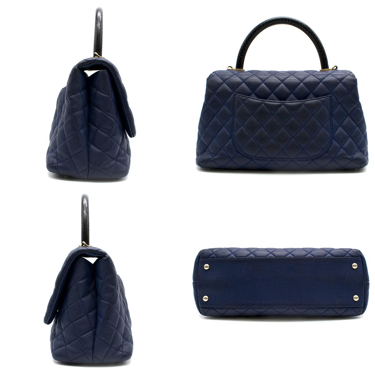 Chanel Navy Caviar Leather Lizard Embossed Top Handle Flap Bag

Navy blue bag
Black Lizard handle 
Quilted caviar leather
Rear slip in pocket. 
Polished CC turn lock closure Leather lined interior  
Two zipper pockets in interior.

Please note,
