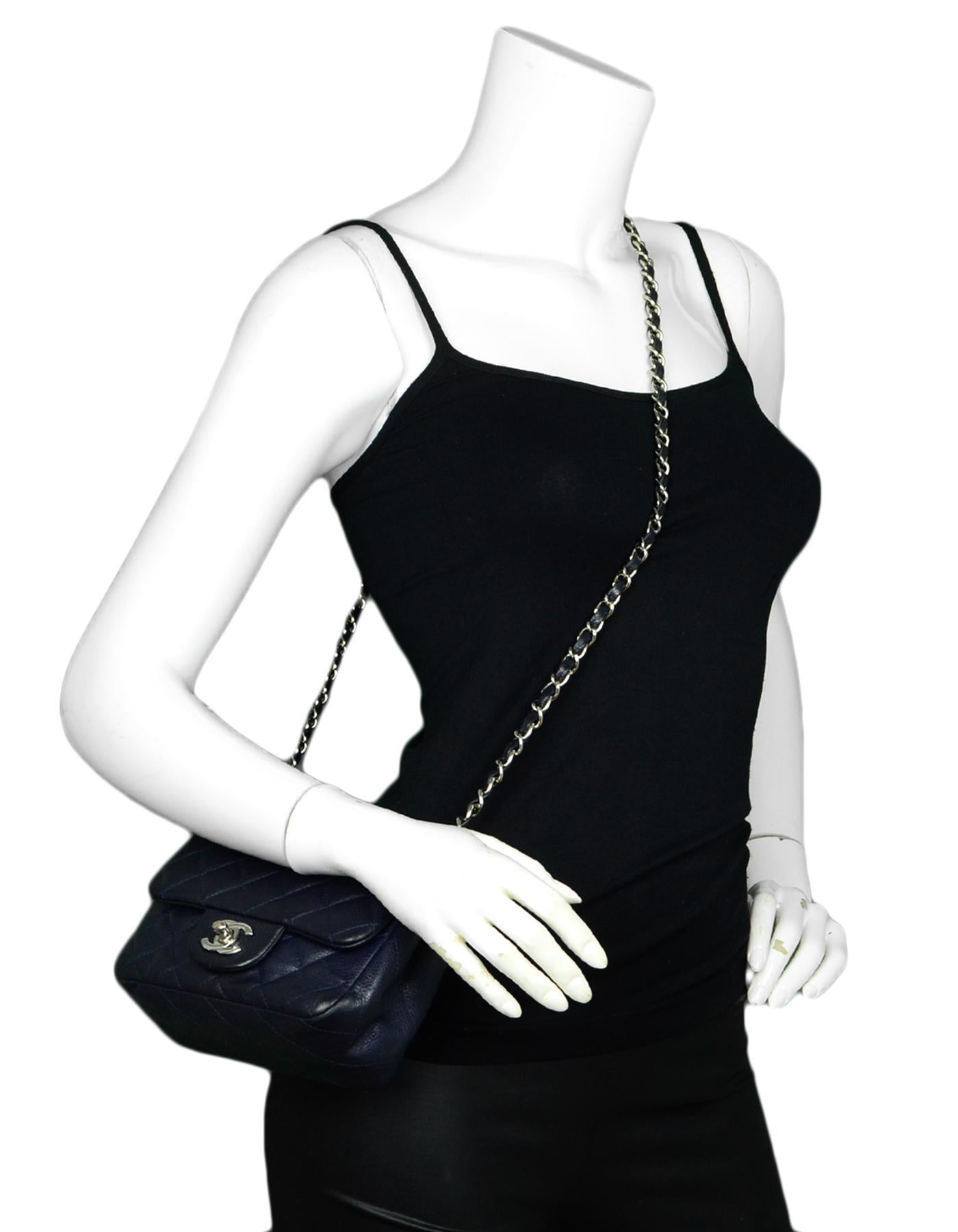 Chanel Navy Caviar Leather Mini Classic Bag

Made In: Italy 
Color: Navy
Hardware: Silvertone
Materials: Caviar Leather
Lining: Leather
Closure/Opening: Top flap with CC turnlock
Exterior Pockets: Rear flat pocket
Interior Pockets: One flat pocket,