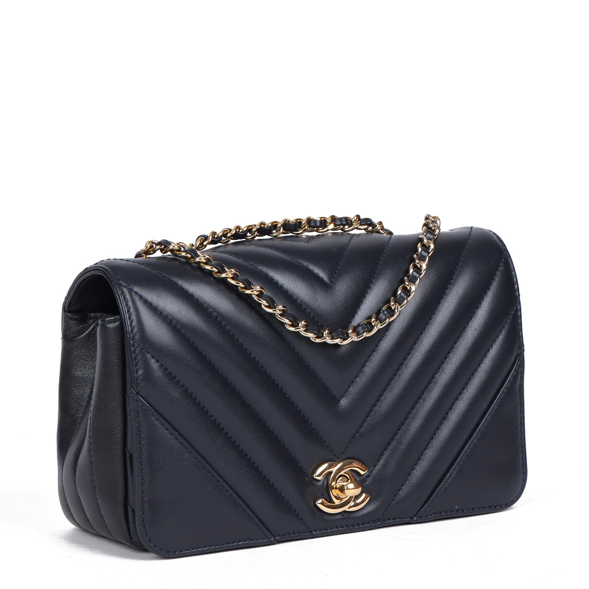 CHANEL
Navy Chevron Quilted Lambskin Mini Statement Classic Single Flap Bag

Xupes Reference: CB572
Serial Number: 28094393
Age (Circa): 2019
Accompanied By: Chanel Dust Bag, Box, Authenticity Card
Authenticity Details: Authenticity Card, Serial