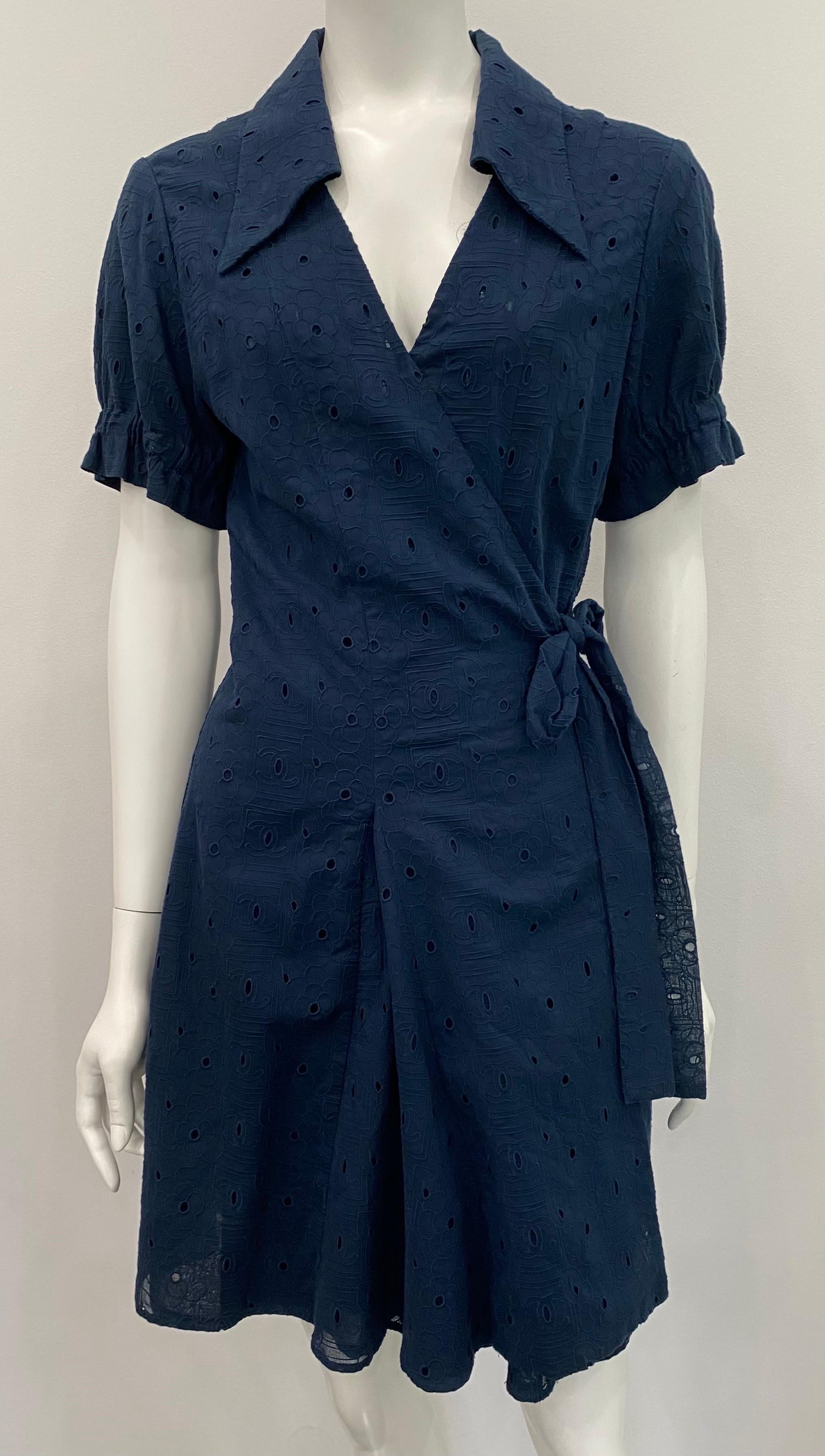 Chanel Navy Cotton Eyelet Wrap Dress - Sz 42 - 07P Chanel ID Collection. This perfect Chanel navy eyelet summer dress is lined in cotton, the wrap dress has short sleeves with an elastic detail creating a slight ruffle illusion to the sleeve, it has