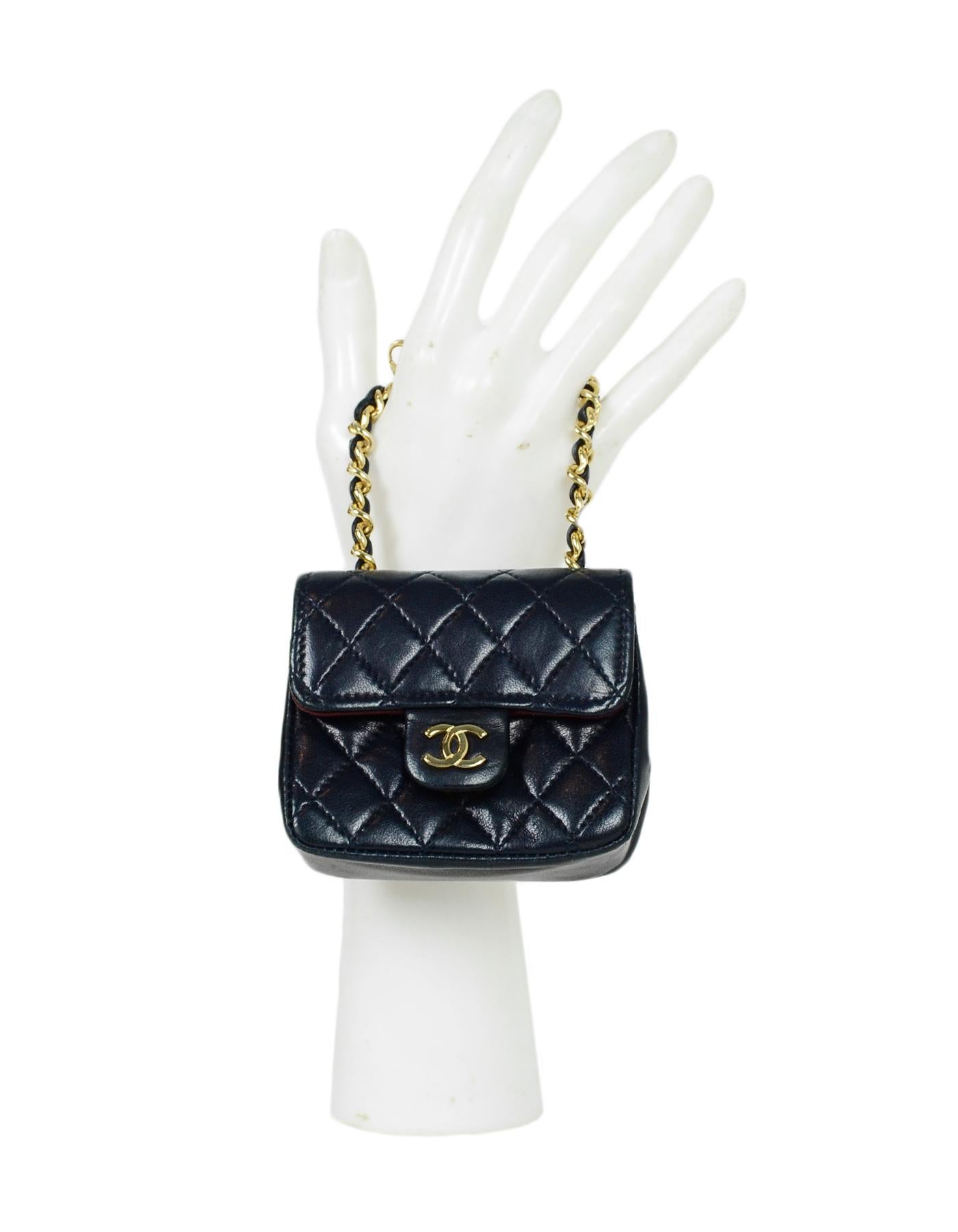 Chanel Navy Lambskin Quilted Micro Mini Flap Bag. This micro mini is to be worn as a belt or bag charm, or can be used as mini pouch to store money and coins. Please note, it is too small to hold credit cards or a phone.

Made In:France
Color: