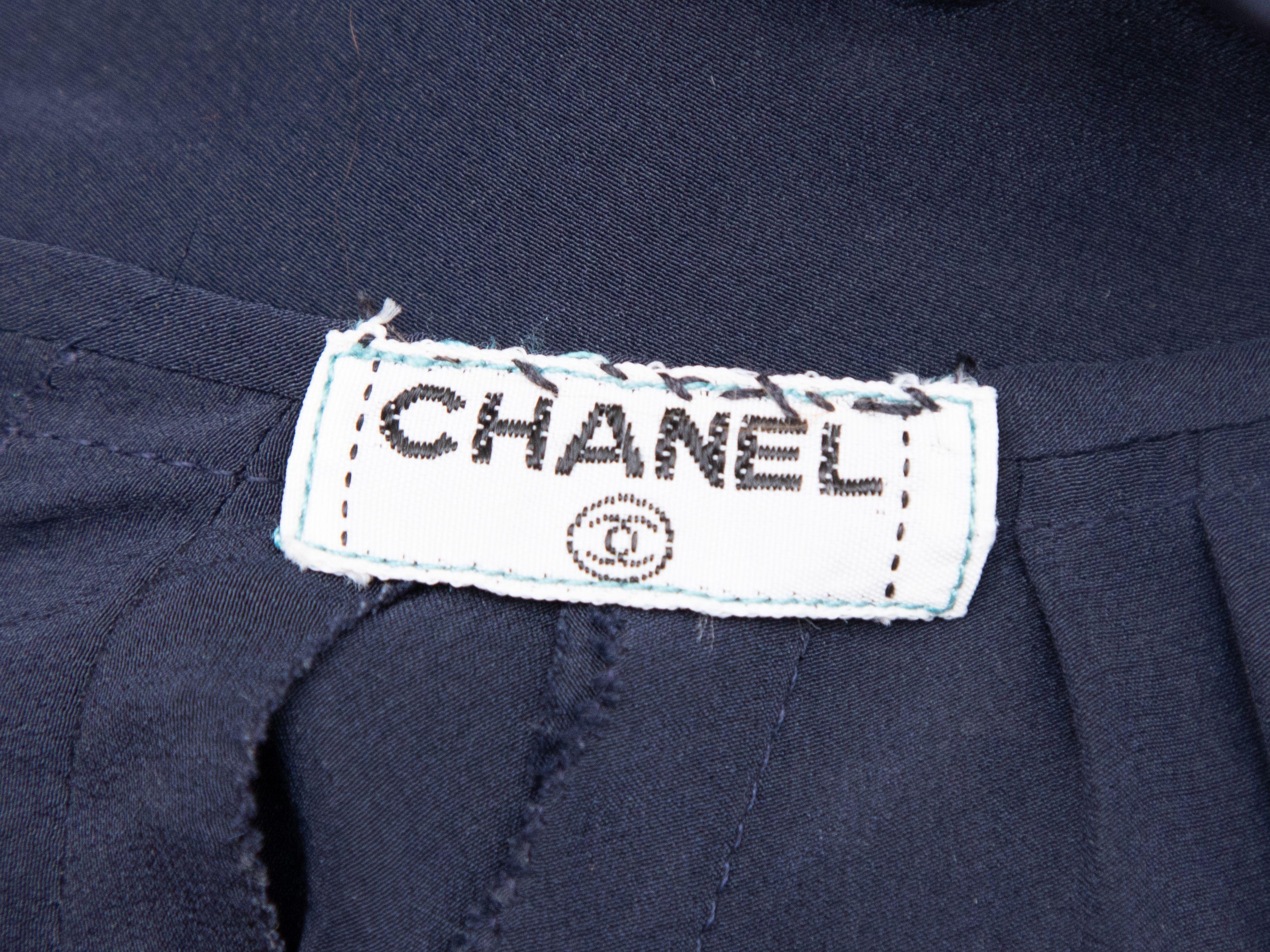 Product Details: Vintage navy long sleeve wrap dress by Chanel. Plunging V-neckline. Gold-tone button closures at nape. 34