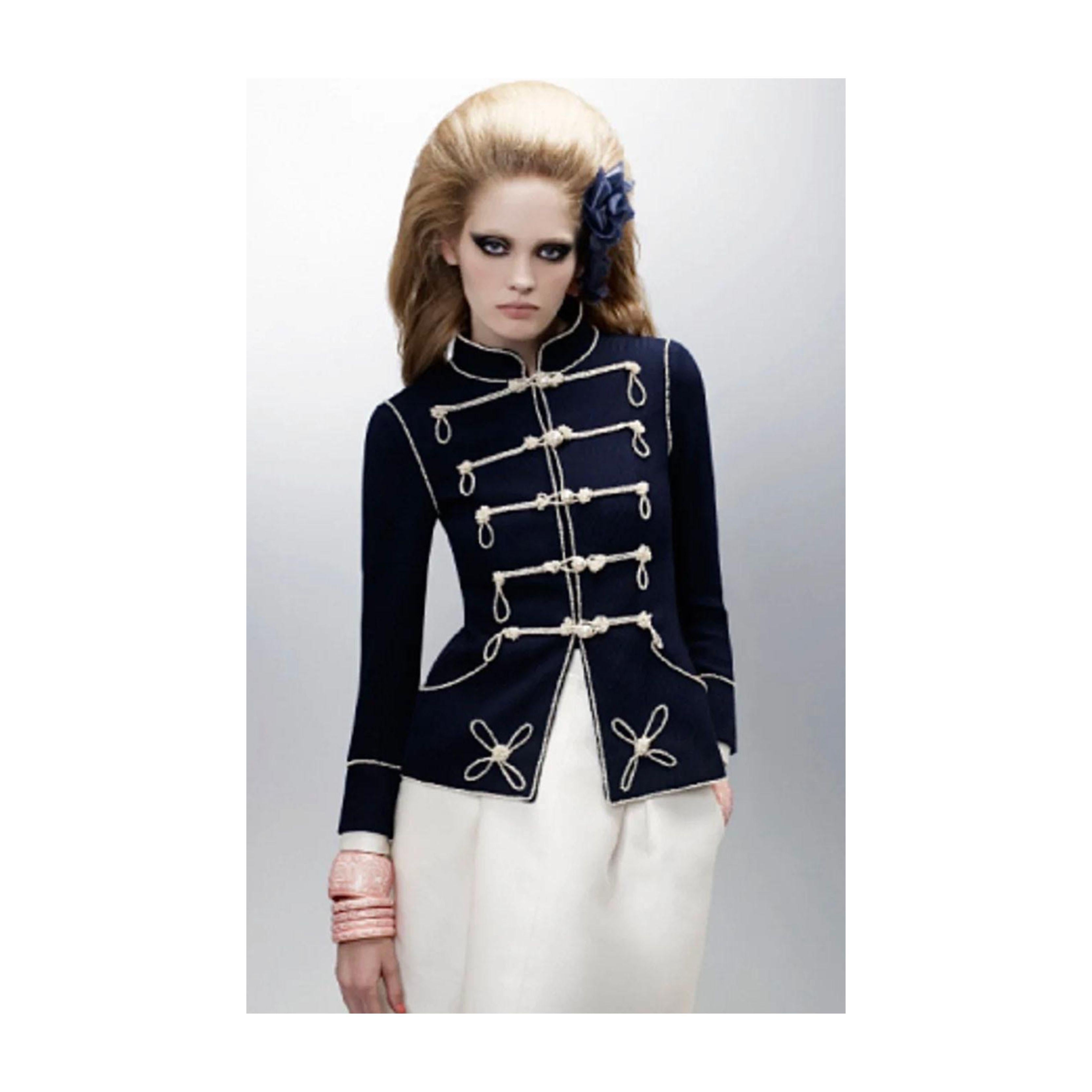 Make a captivating entry with this Chanel Navy Majorette Jacket with Pearls. With a high collar and tucked-in waist, the feminine silhouette is accentuated and the Chanel pearls embellishments give it a refined and graceful look.  Whether you layer