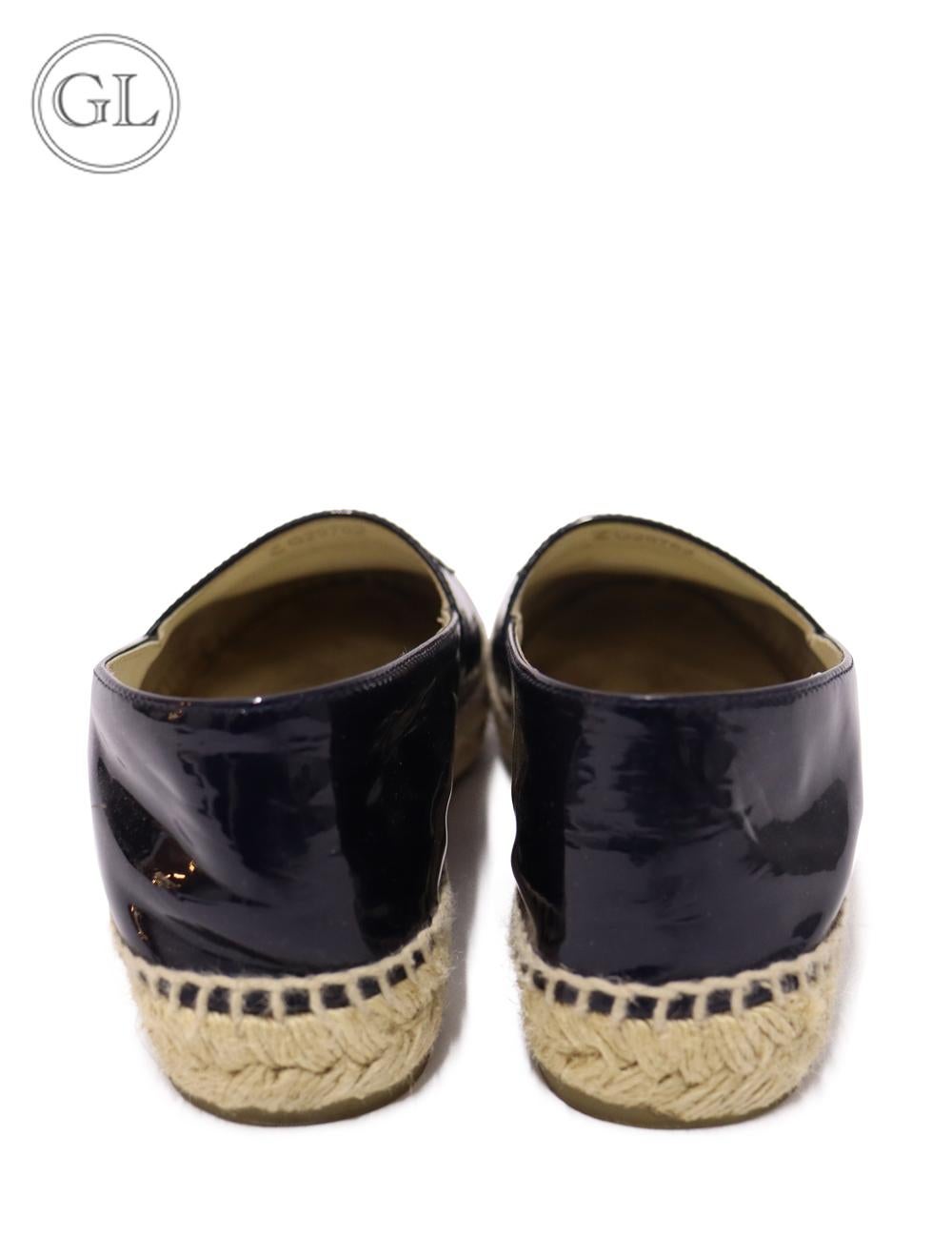 Chanel Navy Patent Lambskin Leather Espadrilles, detailed with the 'CC' interlocked logo on the front.

Material: Leather.
Size: EU 38
Overall Condition: Very Good.
Interior Condition: Signs of wear.
Exterior Condition: Barely there signs of use.