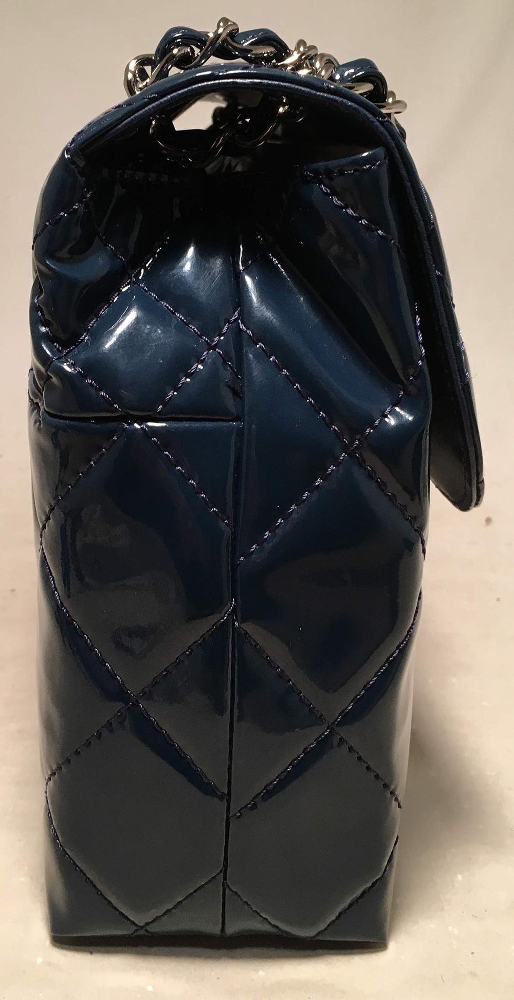 Chanel Navy Patent Leather Jumbo Classic Flap Shoulder Bag in excellent like-new condition. Navy patent leather quilted exterior trimmed with silver hardware and 2 different size quilt patterns along top and bottom. Signature CC logo twist closure
