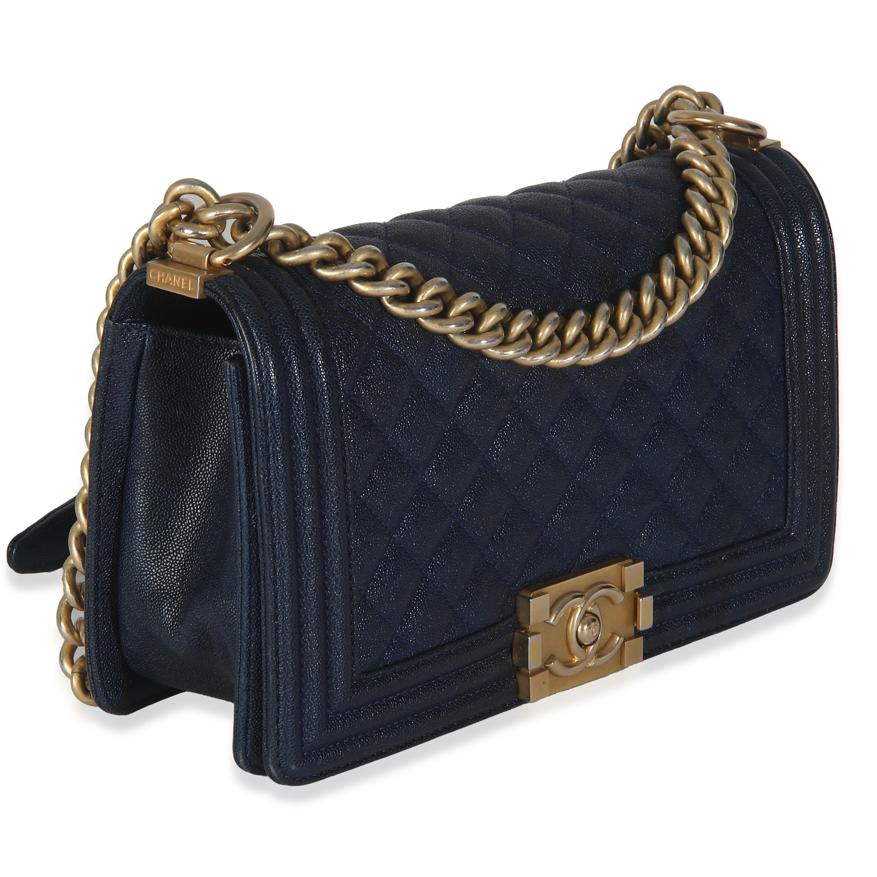 Listing Title: Chanel Navy Quilted Caviar Medium Boy Bag
SKU: 146208
Condition: Pre-owned 
Condition Description: An instant classic, the Boy bag from Chanel was introduced in 2011. The quilted bag was designed by the late Karl Lagerfeld, who was