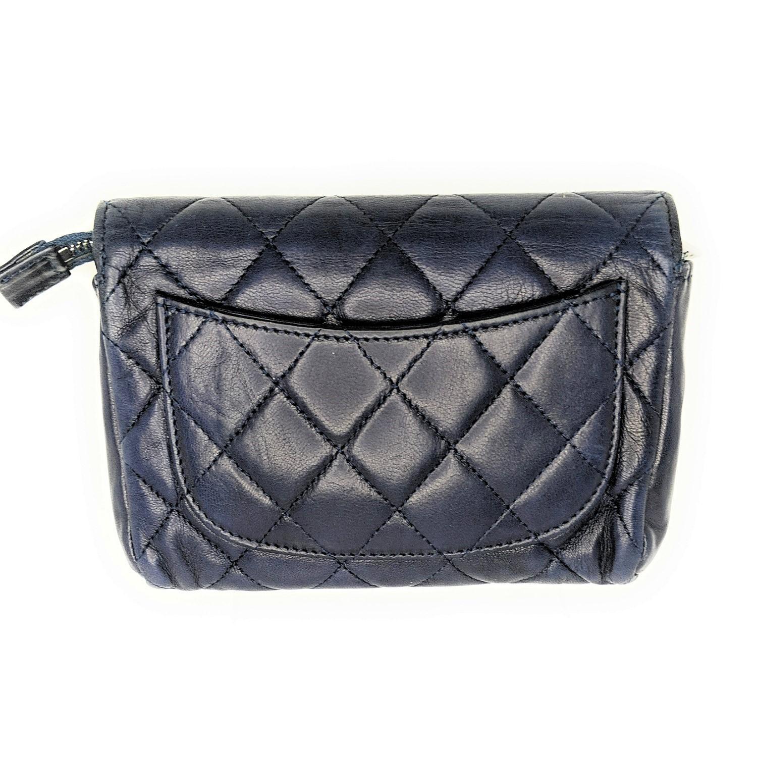 This stylish cosmetics case is crafted of diamond quilted lambskin leather in navy with a small silver Chanel CC logo. The top flap and zipper opens to a nylon compartment with room for all your cosmetic needs and a mirror on the inner side of the