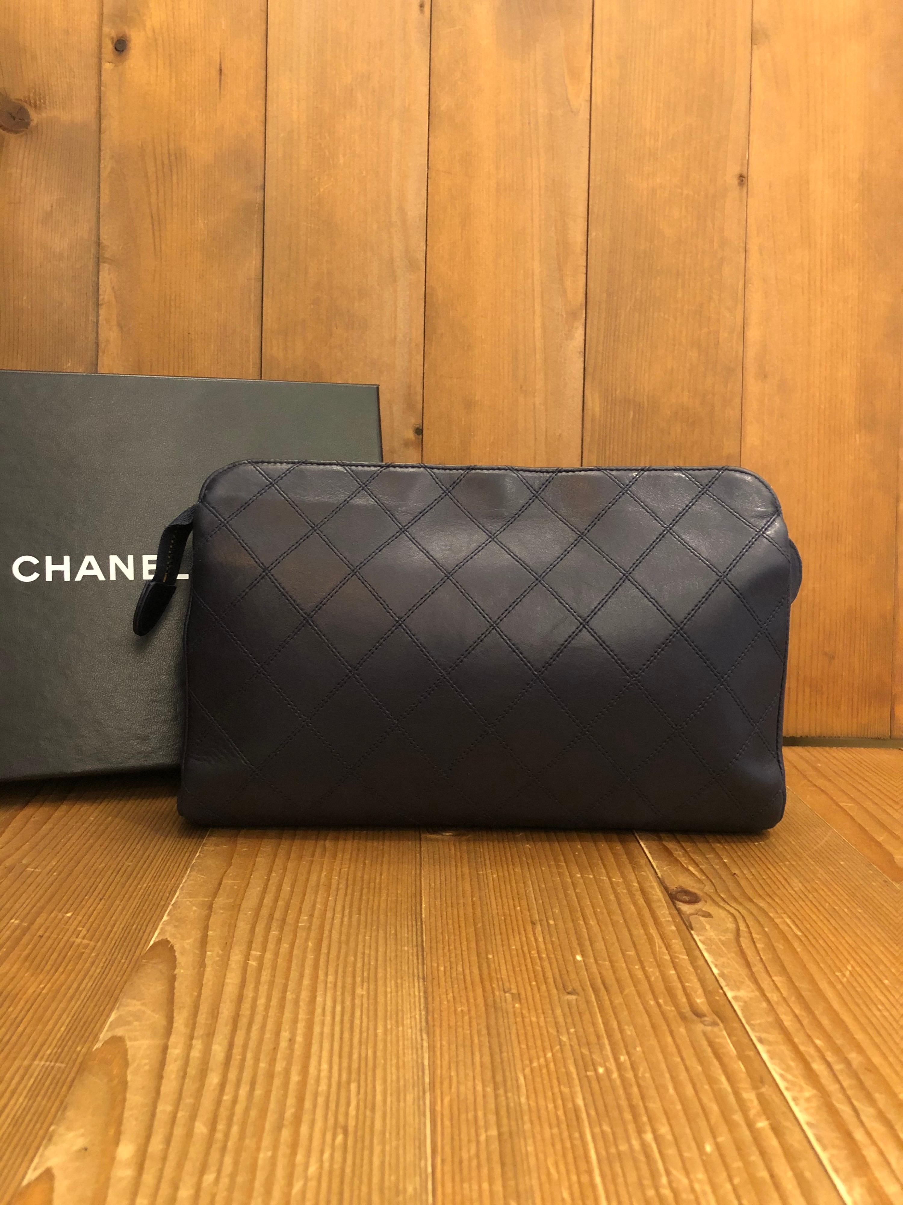 1990s Chanel Clutch in dark navy quilted Lambskin. Interior fully refurbished by Chanel store. Original tags preserved but holo sticker removed. Comes with original Chanel box.

Material: Lambskin leather 
Color: Navy
Origin: France 
Measurements: