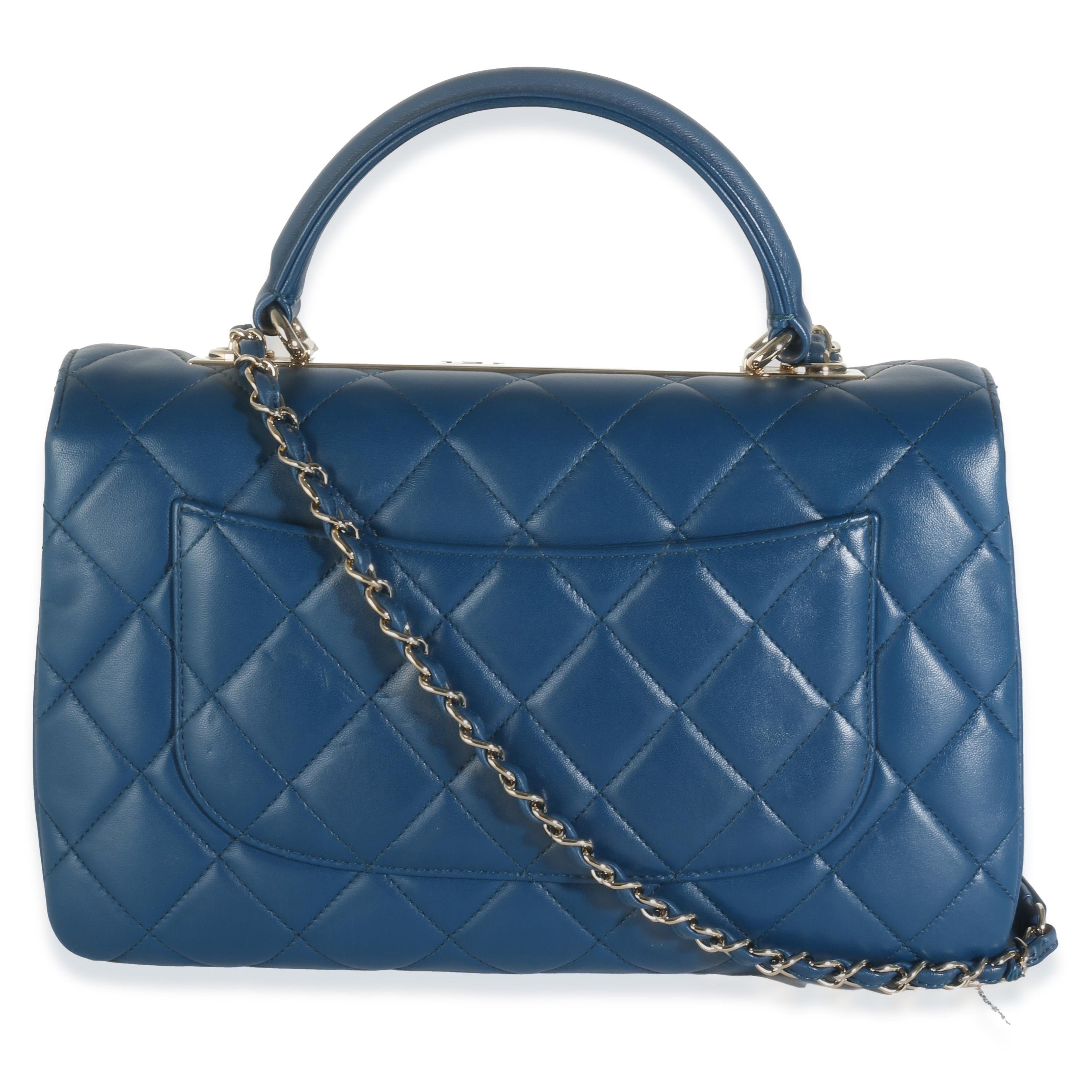 Listing Title: Chanel Navy Quilted Lambskin Medium Trendy Top Handle Bag
SKU: 142557
Condition: Pre-owned 
Condition Description: Intrinsically Chanel, the medium Coco top handle bag was named after the maison's founder. Introduced in 2015, the bag