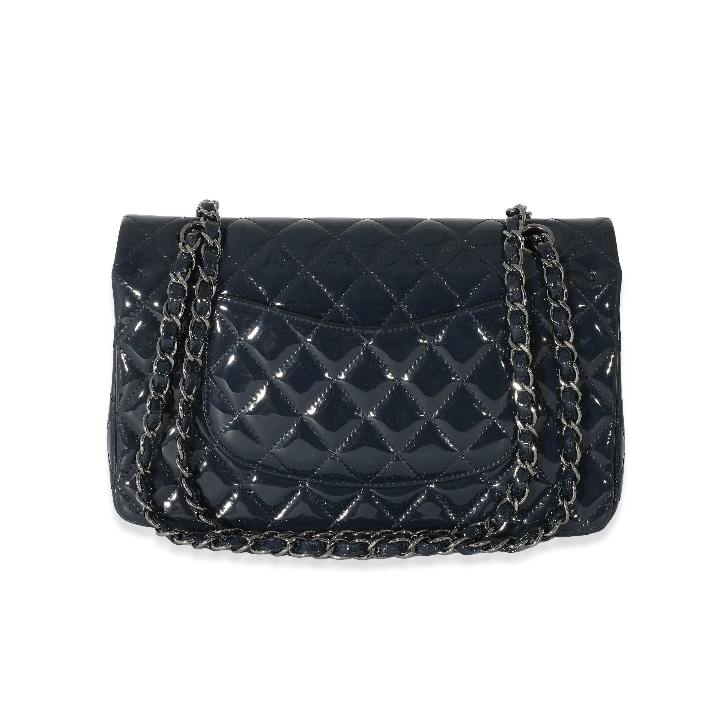Listing Title: Chanel Navy Quilted Patent Medium Classic Double Flap Bag
SKU: 134212
Condition: Pre-owned 
Condition Description: A timeless classic that never goes out of style, the flap bag from Chanel dates back to 1955 and has seen a number of