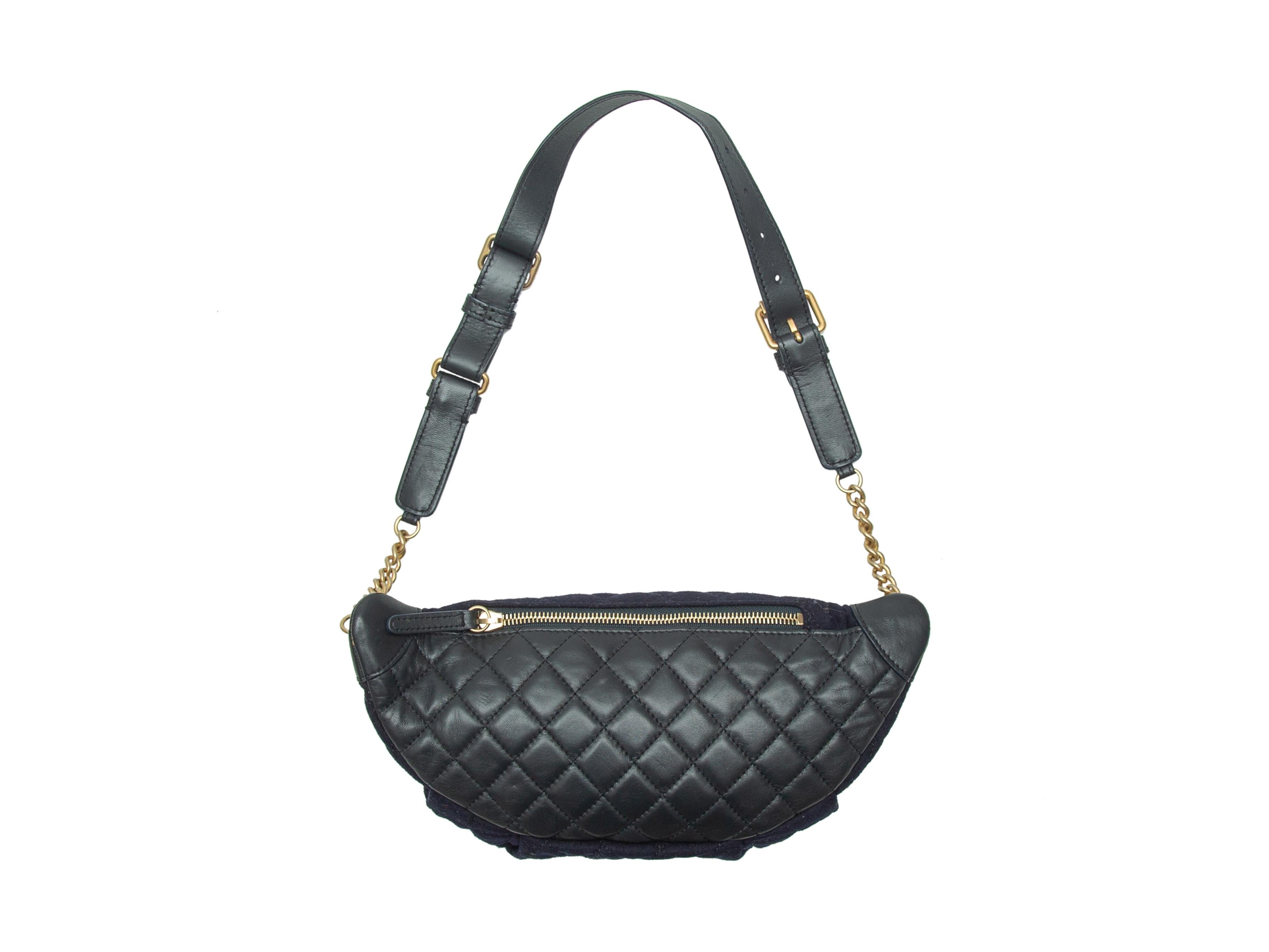 Product details: Navy quilted felt waist bag by Chanel. Gold-tone hardware. Adjustable waist strap. Maritime-themed pin accents at front. CC-accented zip closure at top. 13.5