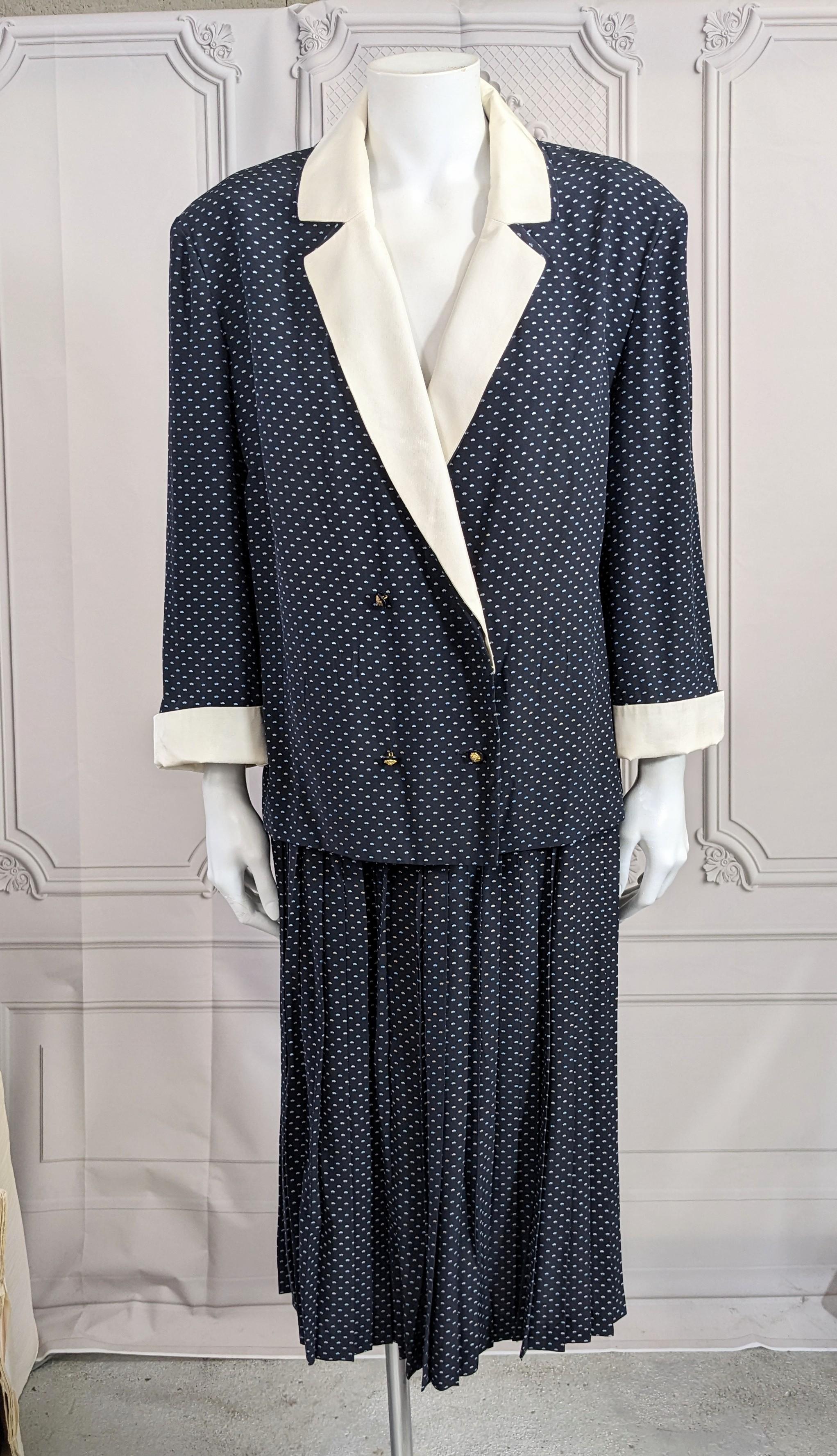 Classic and Elegant Chanel Navy Silk Crepe Skirt Suit with knife pleated skirt from the early 1980's. Unstructured boxy blazer with shoulder pads and 3/4 sleeves made of printed silk crepe and white silk twill fits like a soft shirt.
Jacket is