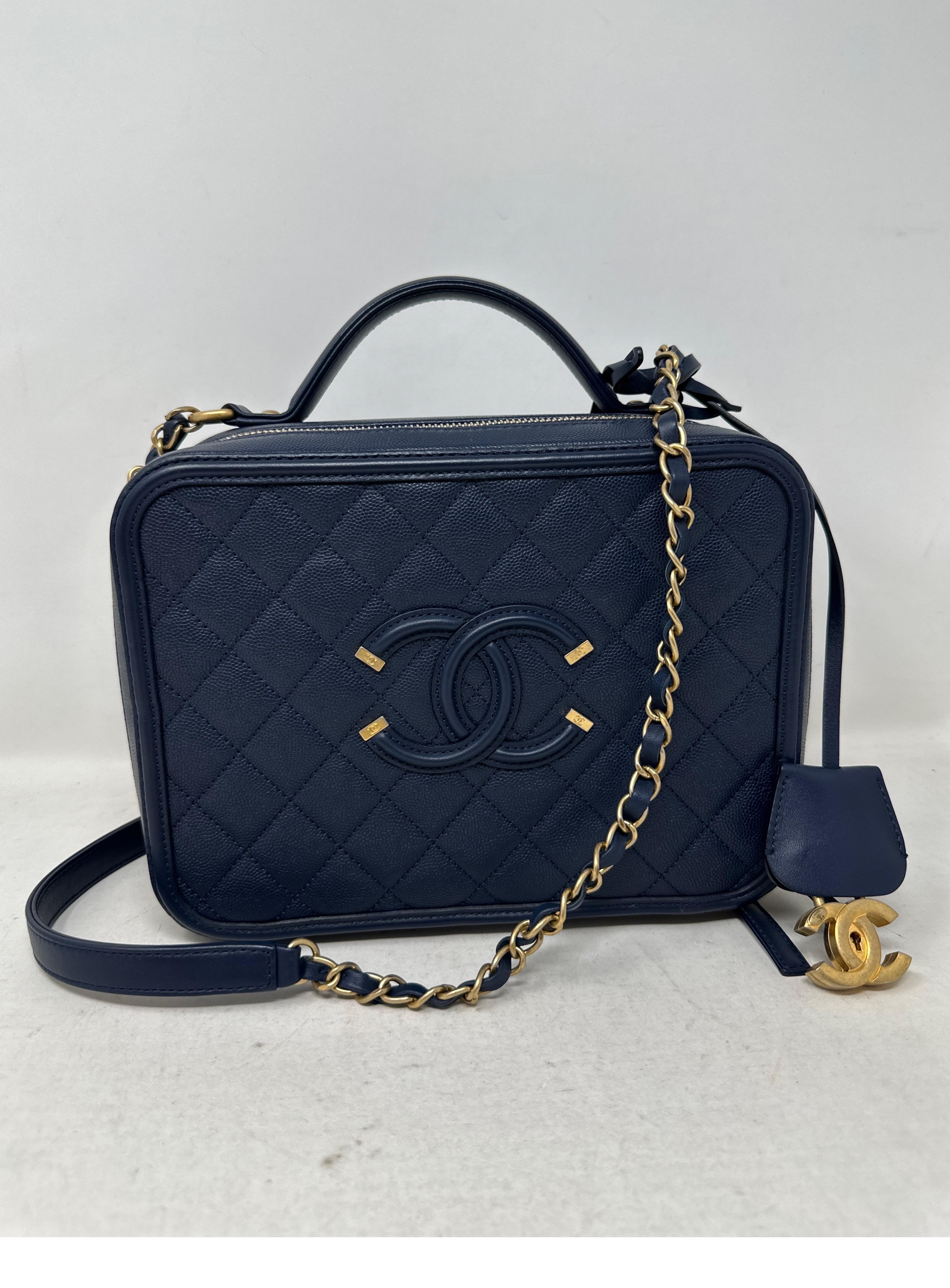 Chanel Navy Vanity Bag. Excellent condition like new. Caviar navy leather bag. Gold hardware. Can be worn as a shoulder bag or a top handle bag. Interior clean. Serial number is intact. Includes dust bag and box. Guaranteed authentic. 