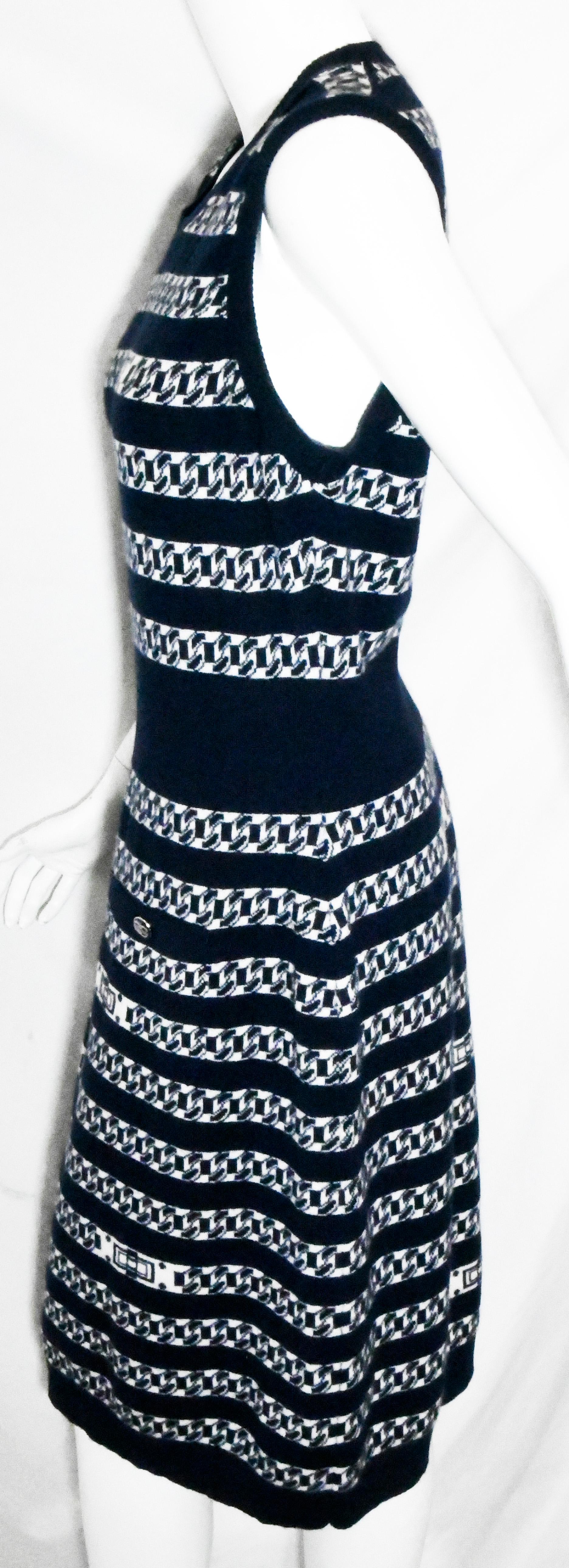 Chanel navy and white cashmere Intarsia chain link pattern knit sleeveless dress from the 2017 Spring Collection. Dress is knitted in a striped design with alternating navy and white and white with navy throughout.  Dress is unlined and includes