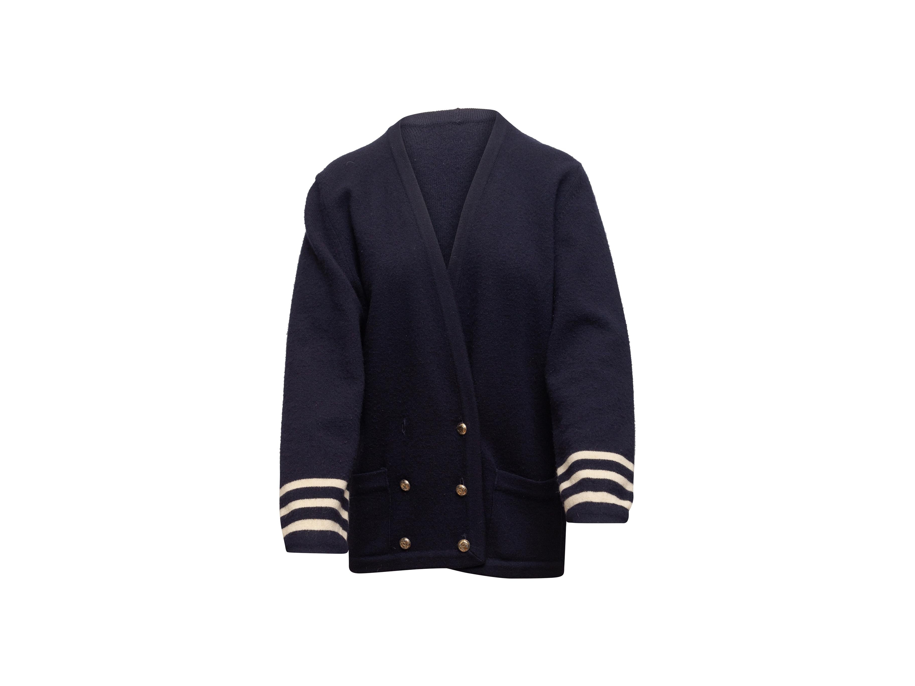Product details: Vintage navy and white cashmere double-breasted cardigan by Chanel. V-neck. Dual hip pockets. Button closures at front. 42