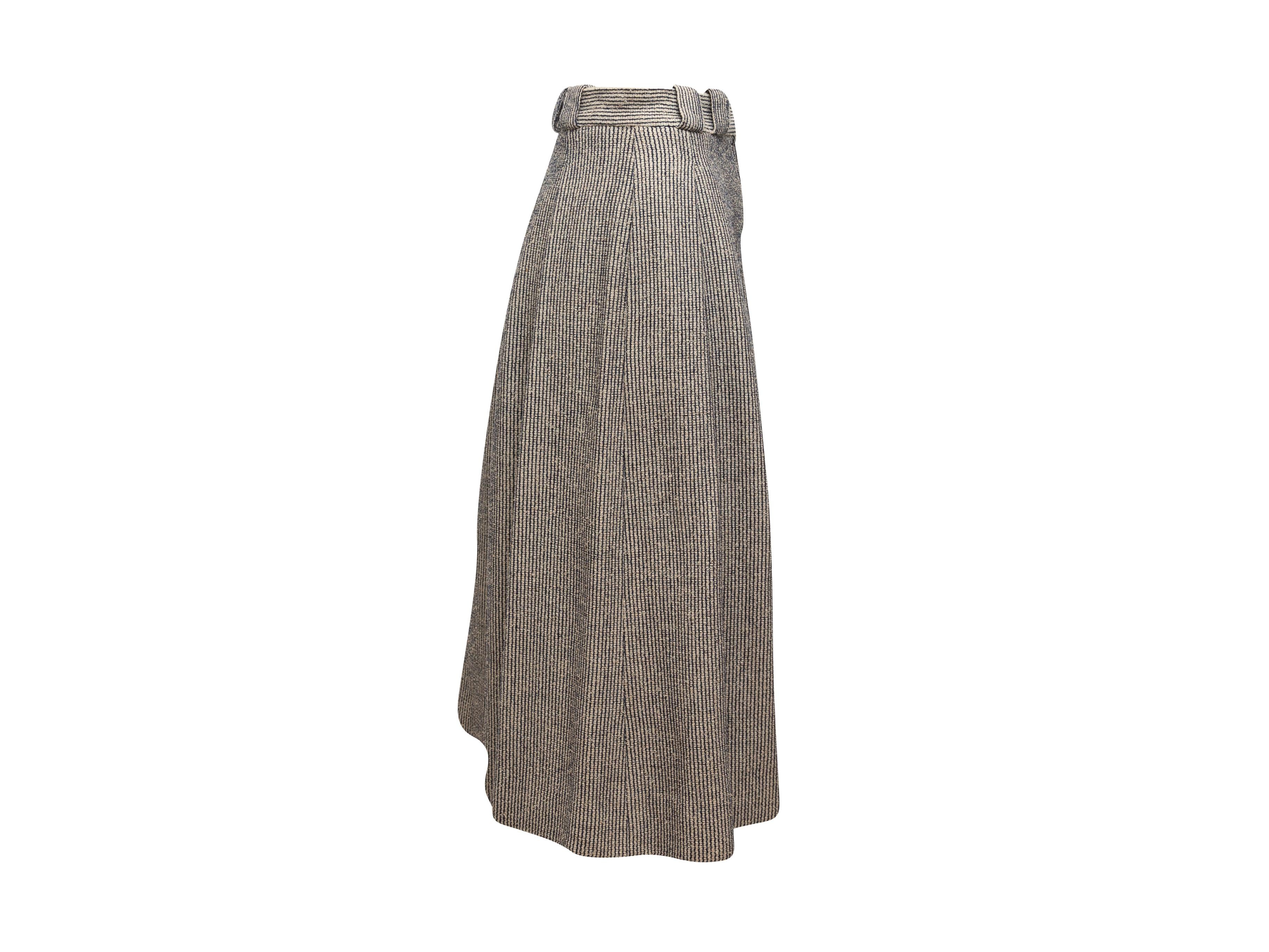 Product details: Vintage navy and white tweed pleated skirt by Chanel. Belt loops at waist. Zip closure at side. 26