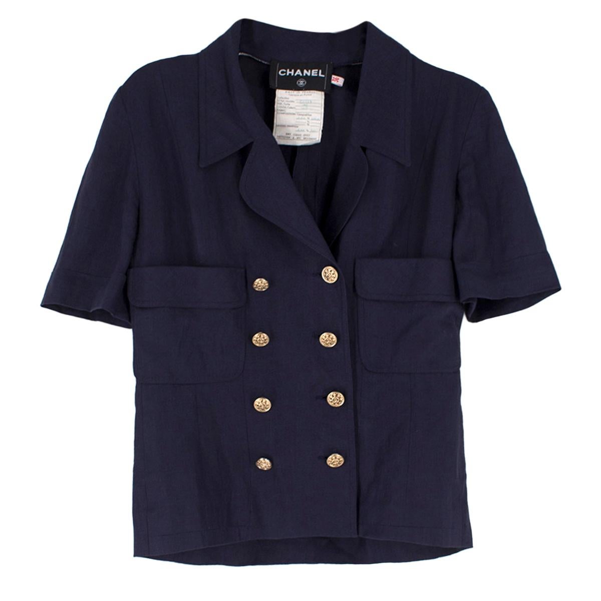 Chanel Navy Wool Short Sleeve Jacket

- Navy jacket
- Short sleeved
- Notch lapel, double breasted 
- Gold toned buttons 
- Decorative side flap pockets
- Unlined

Please note, these items are pre-owned and may show some signs of storage, even when