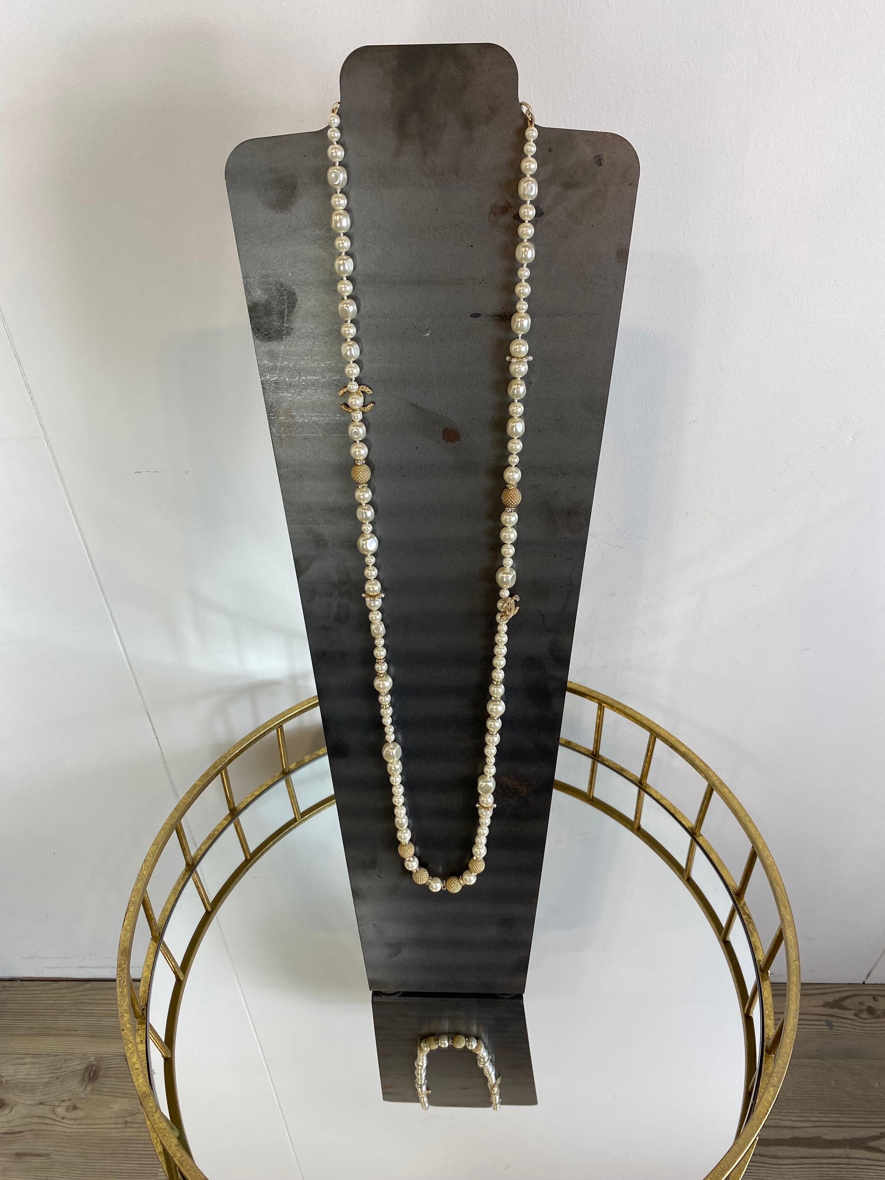 Collana lunga di Chanel con perle e strass
Collana di perle Chanel con strass sia sul logo 'CC' che altrove.
Mancano 3 pietre come mostrato nella foto.
Si alternano perle più grandi e perle più piccole. Altre quantità di chiusura. In alcuni punti le