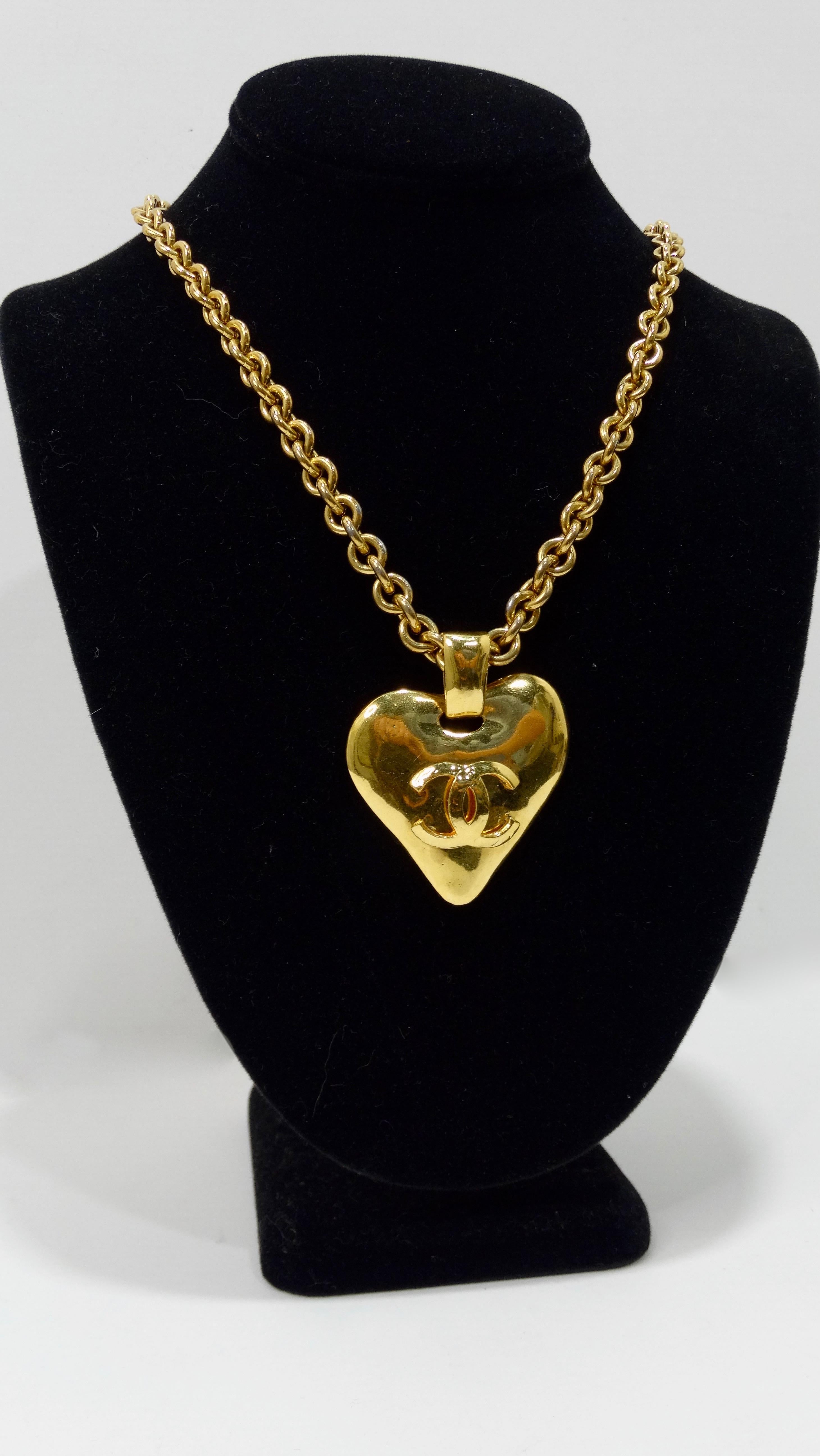 Show your love for Chanel with this amazing necklace! Circa 1993 from their Spring collection, this gold tone chain link necklace features a large heart pendant complete with the signature CC logo. Stamped 93P Made in France. Classic and timeless,