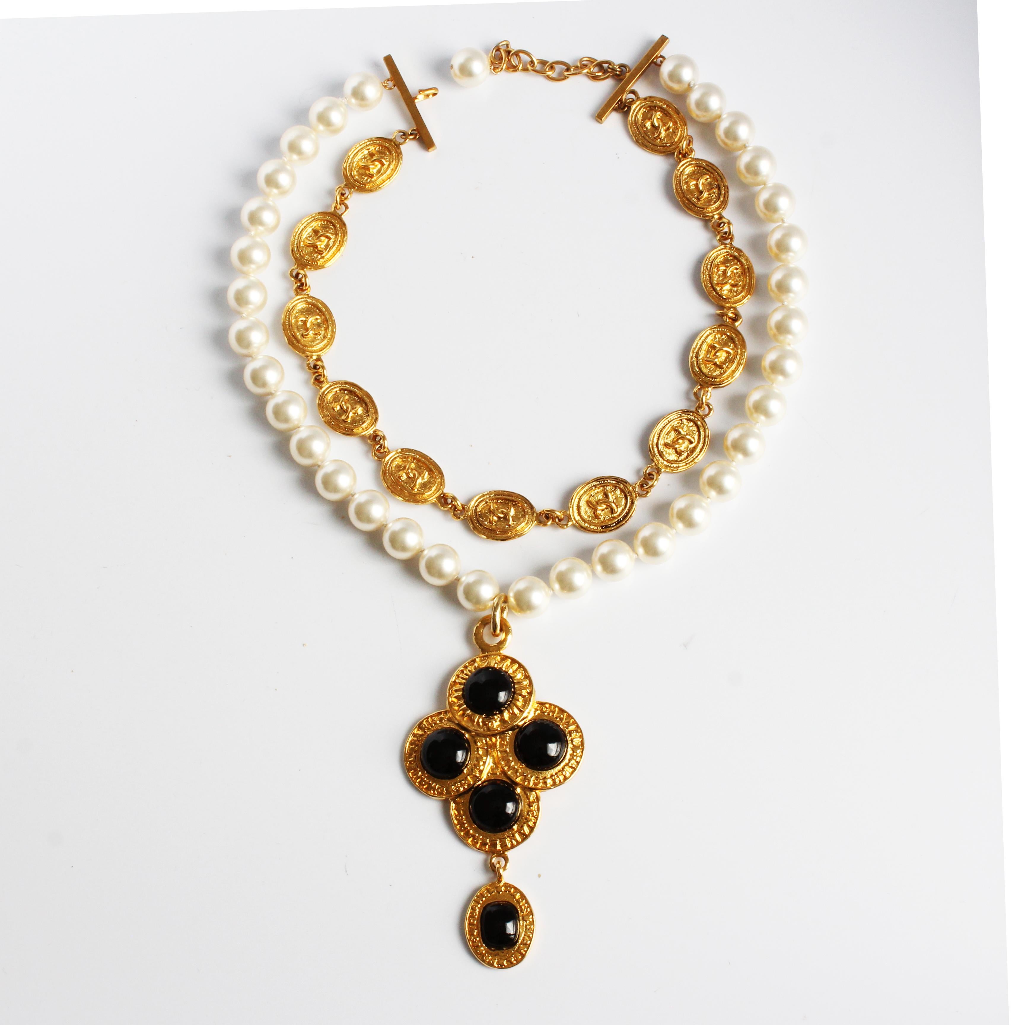 Authentic, preowned, vintage Chanel pendant choker necklace, from the 1991 Season 2 8 collection. The necklace is double-strand with one row of faux pearls and a shorter string of gold CC logo medallions, which fasten with a hook and faux pearl