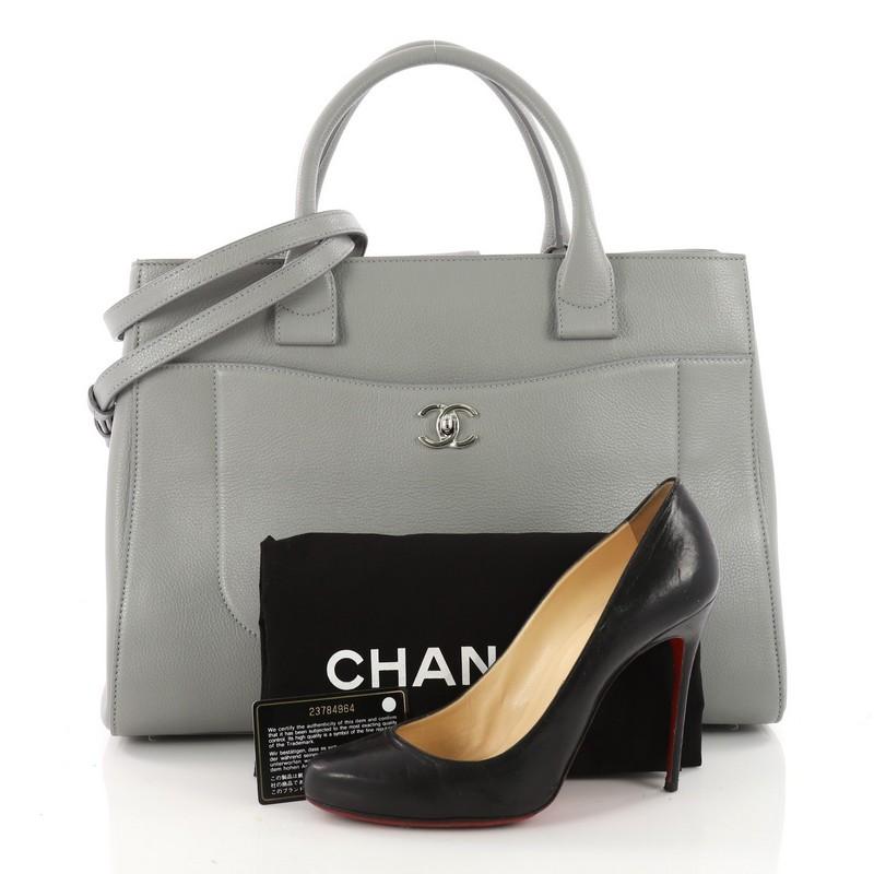 This authentic Chanel Neo Executive Tote Grained Calfskin Medium is the ideal everyday accessory for the modern woman. Crafted from beautiful grey grained calfskin leather, this functional tote features dual-rolled leather handles, front pocket with