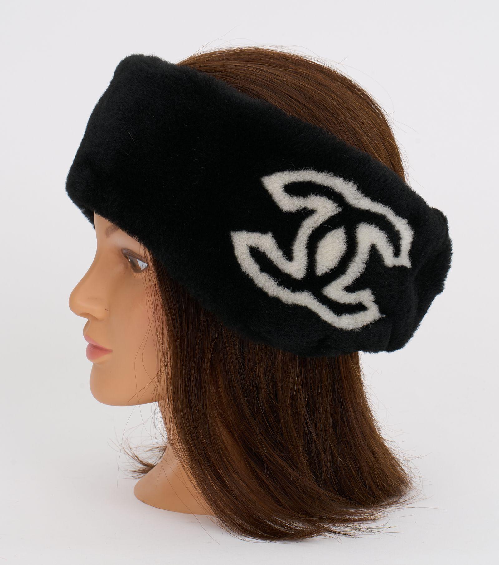 Black and white Chanel Headband made out of shearling. The logo 