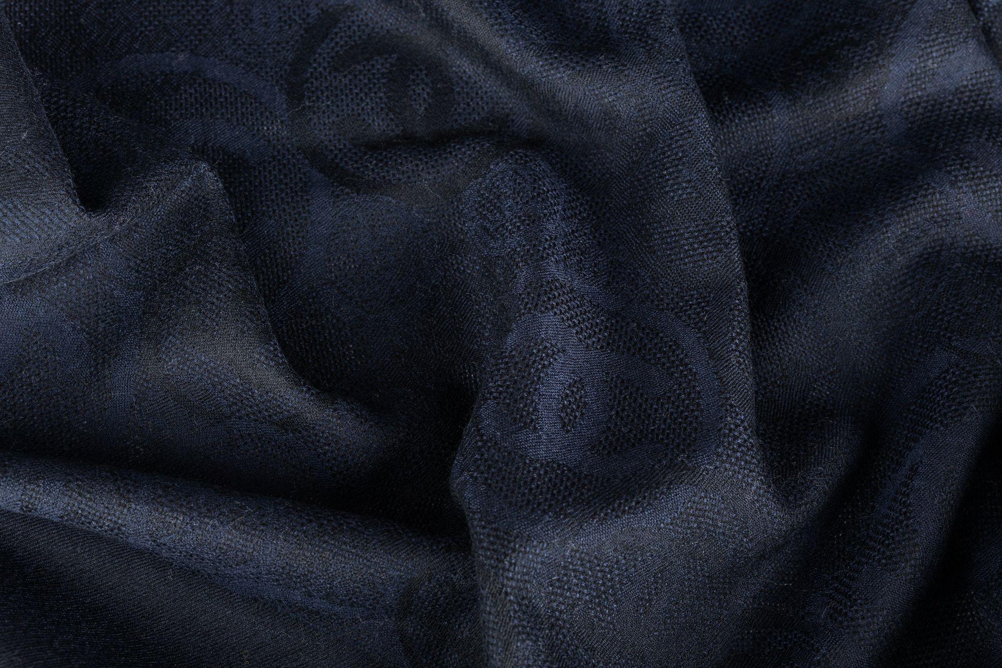 Chanel Cashmere Shawl in navy. The pattern features several CC logos all over the scarf. The item is in new condition.