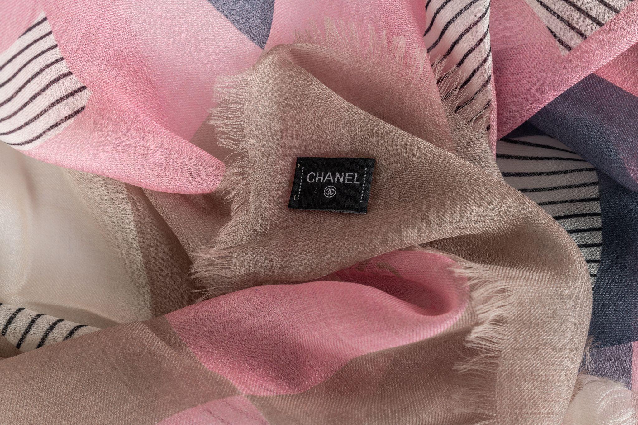 Chanel Cashmere Shawl with a Checkered Pattern in the colors light blue and rose plus CC logo prints. The item is in new condition.