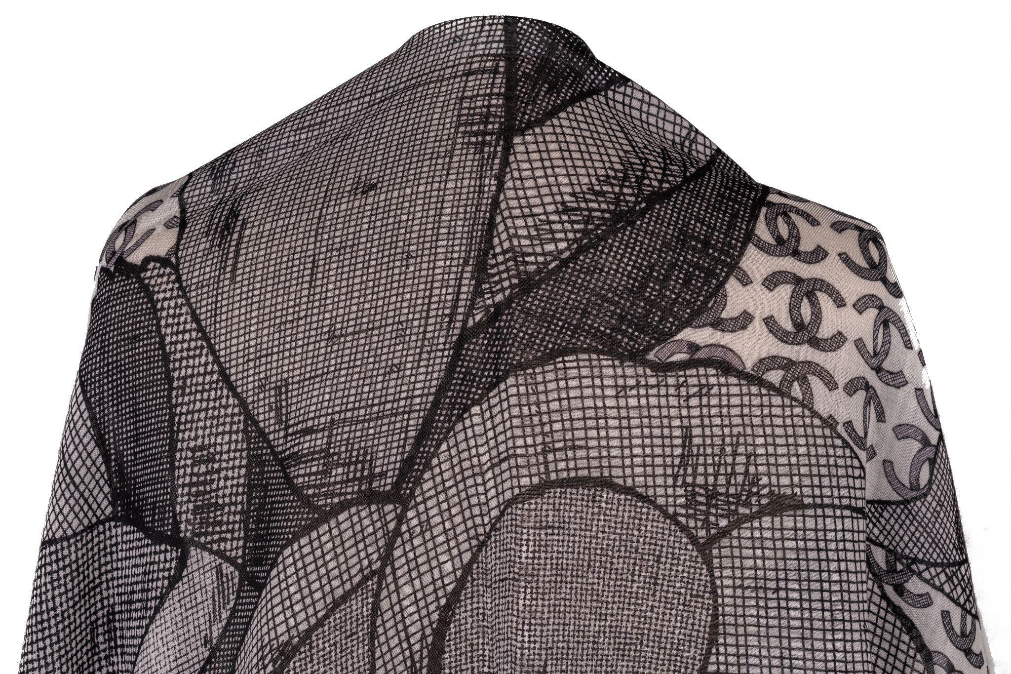 Chanel Kaschmirschal in Grau. Das Muster zeigt eine große Chanel-Kamelie, die von mehreren CC-Logos umgeben ist. Der Artikel ist in neuem Zustand.